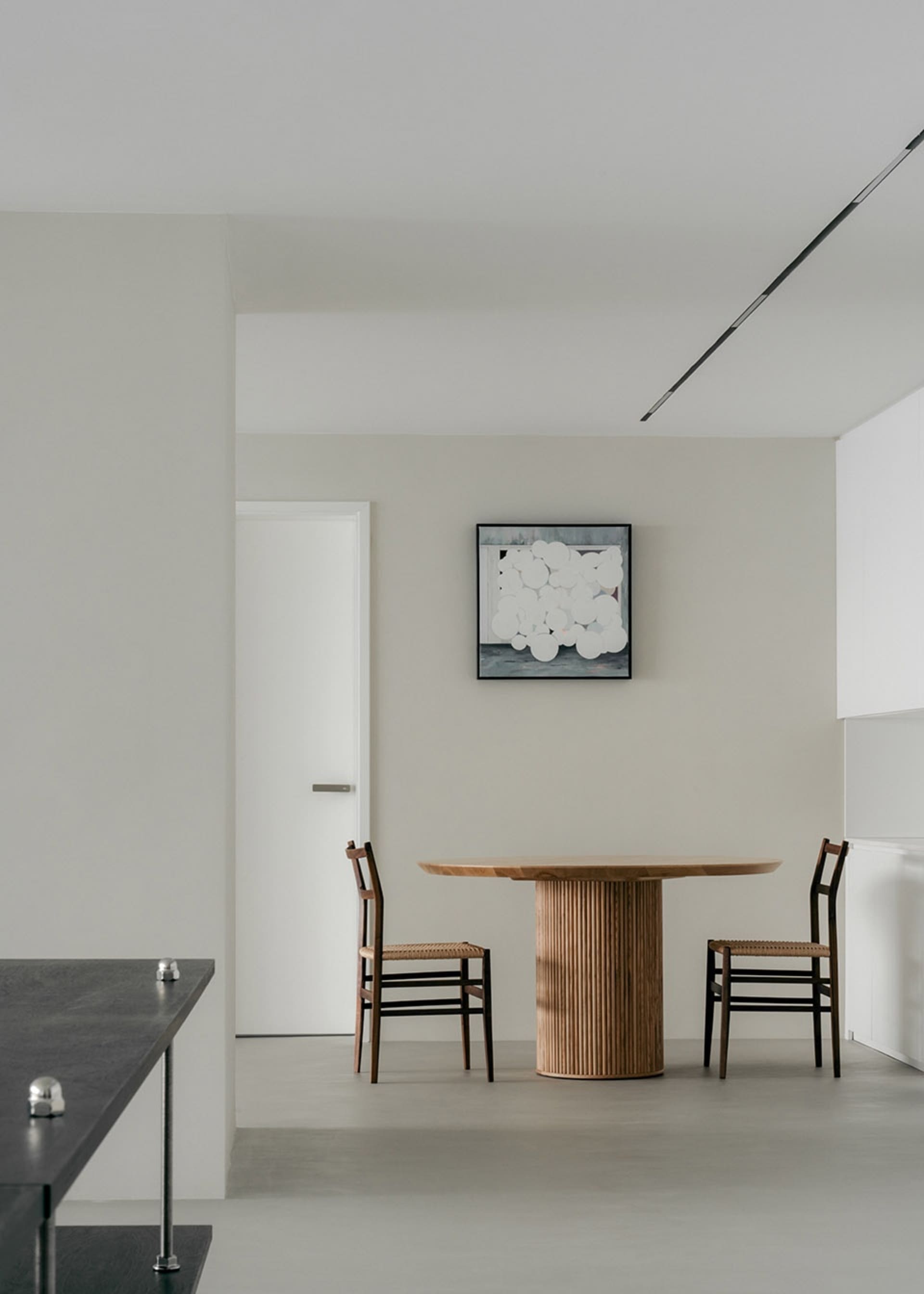 Minimalist dining room featuring a floating wood dining table.