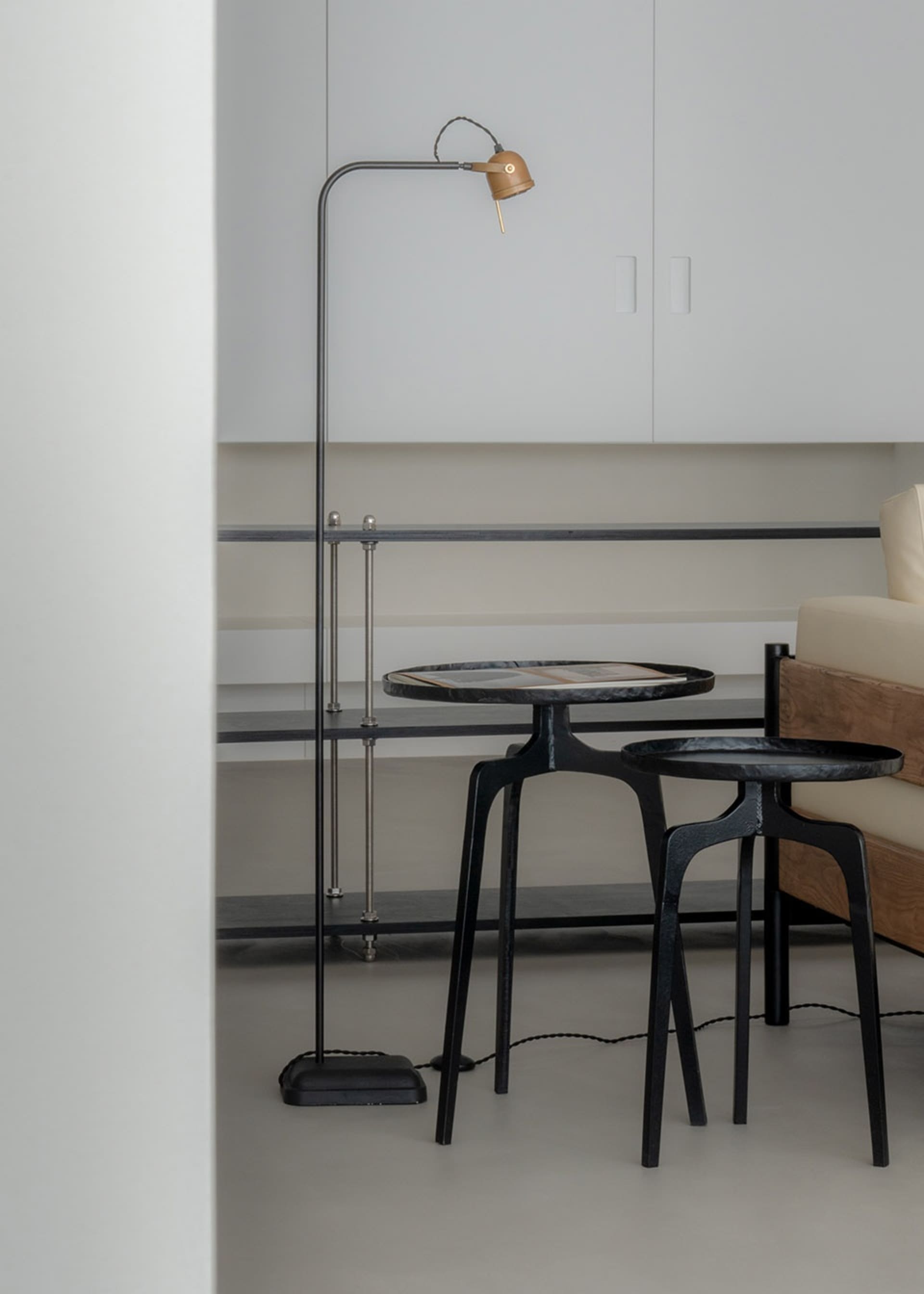 A modern living space featuring a metal floor lamp and a marble coffee table.