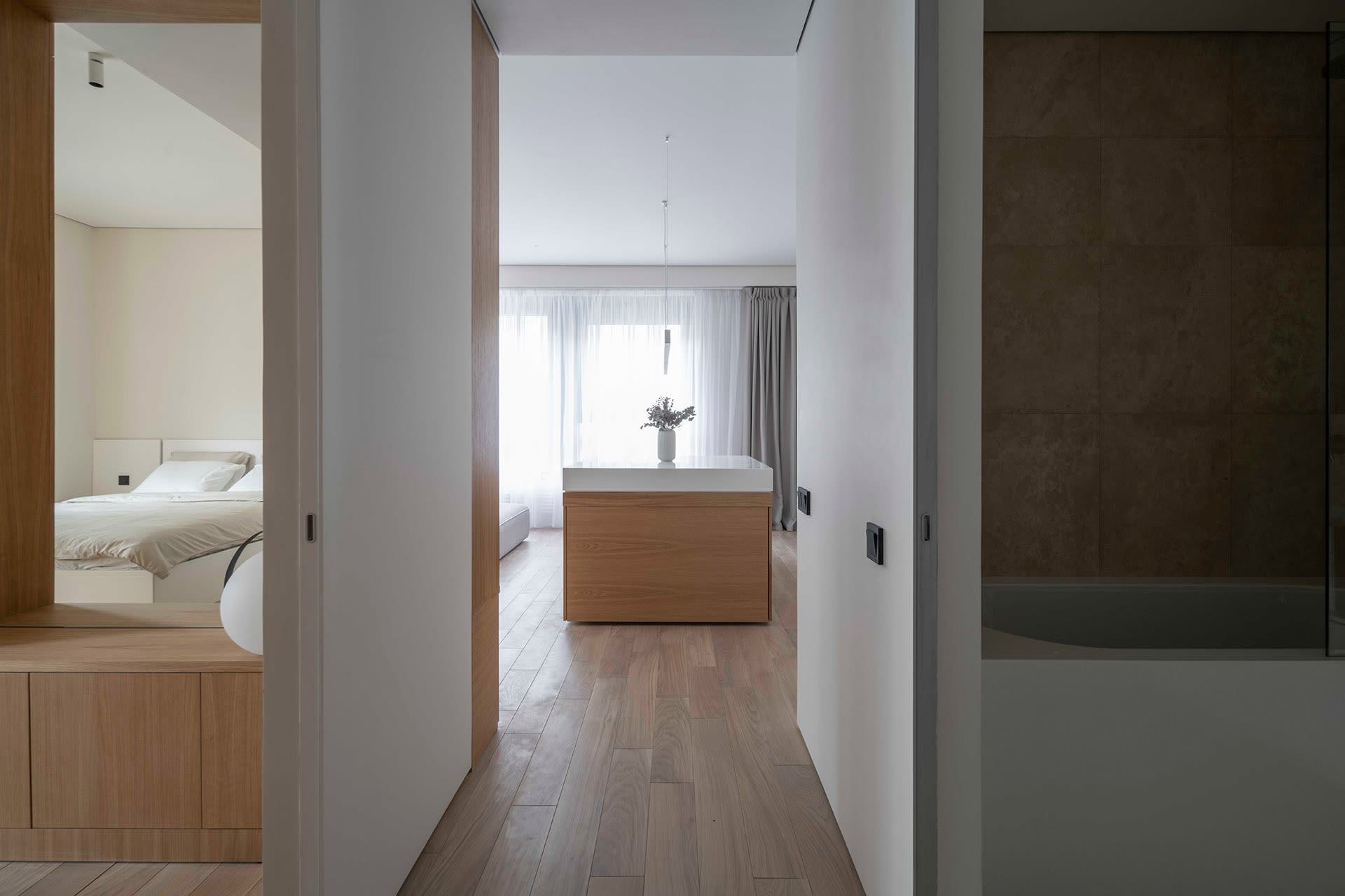 Modern residential interior featuring wood, glass, and concrete materials.