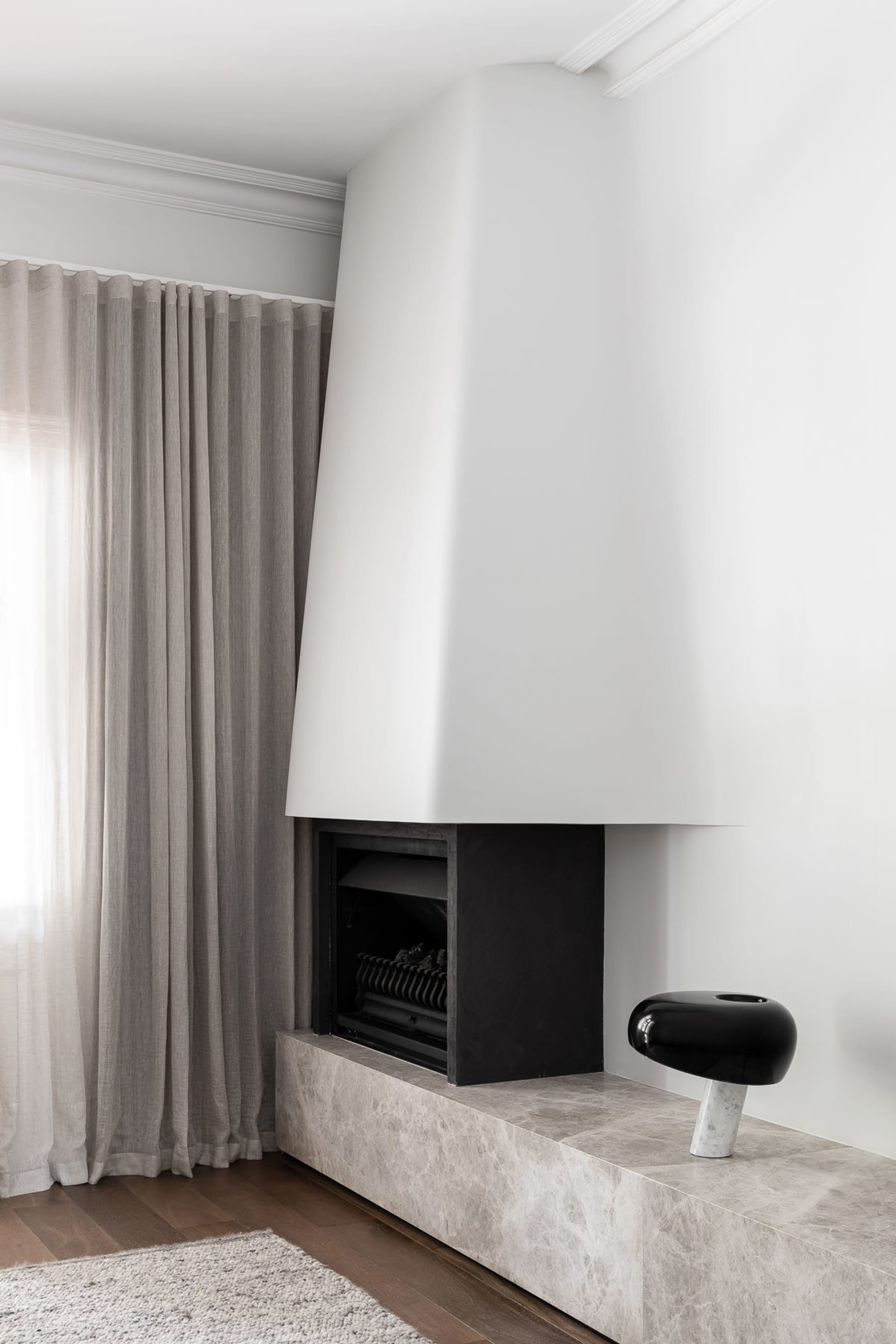 Minimalist living room featuring a marble fireplace and a sleek, modern design.