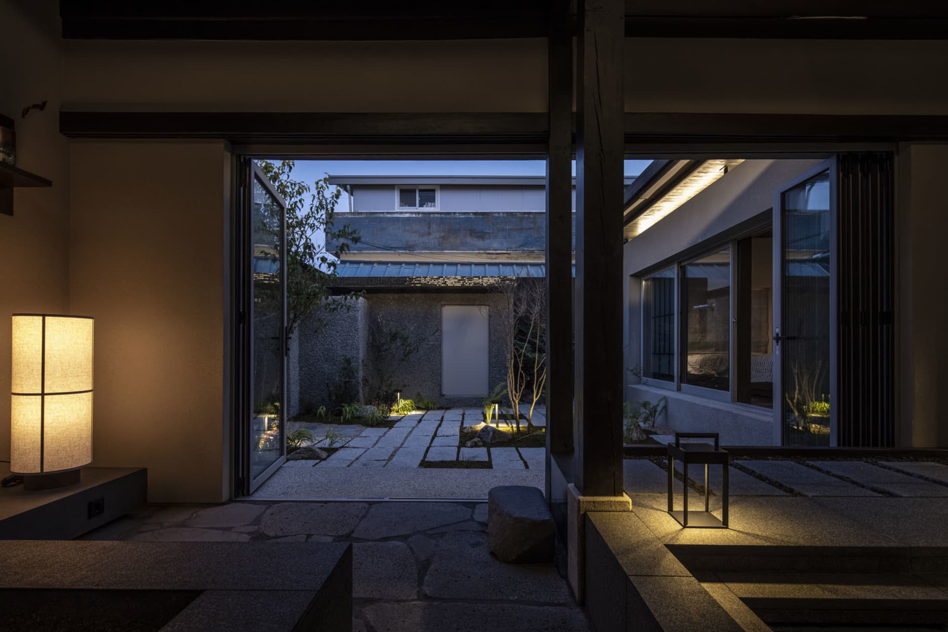 Minimalist residential interior with concrete, glass, and metal elements.