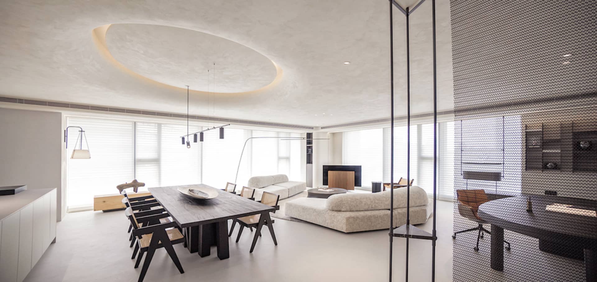 A modern living room with neutral tones and minimalistic design elements.