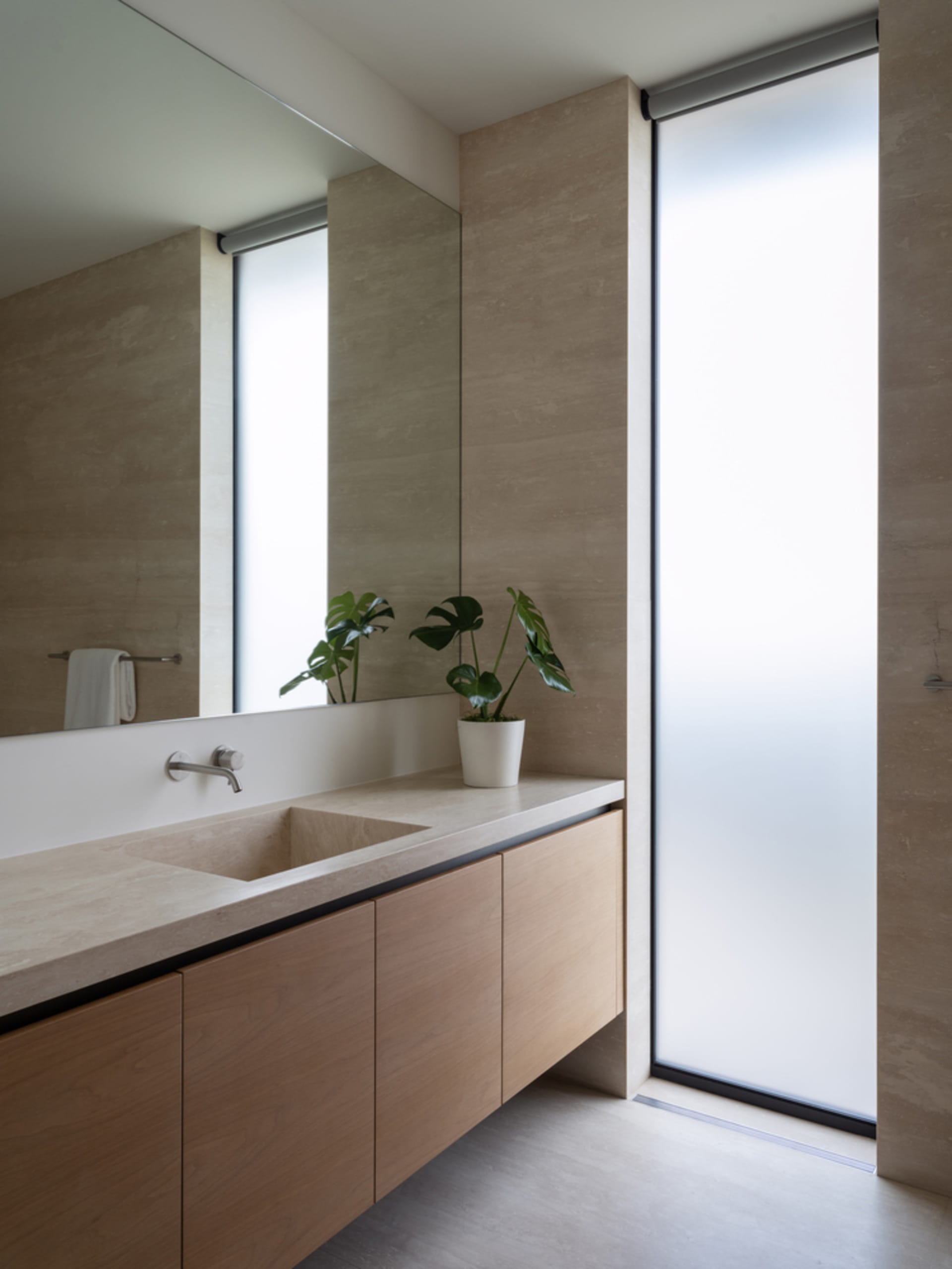 Minimalist bathroom featuring a concrete countertop and sink.