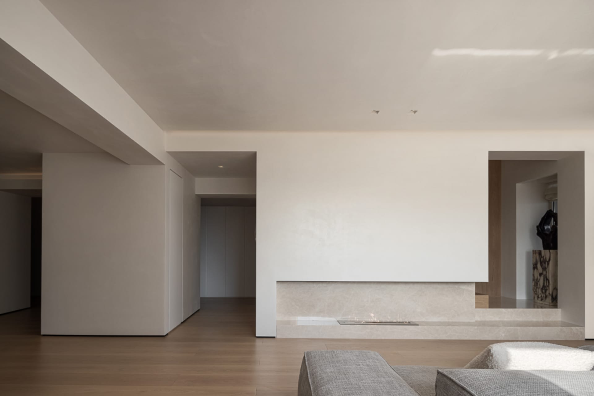A modern minimalist living room with marble elements.