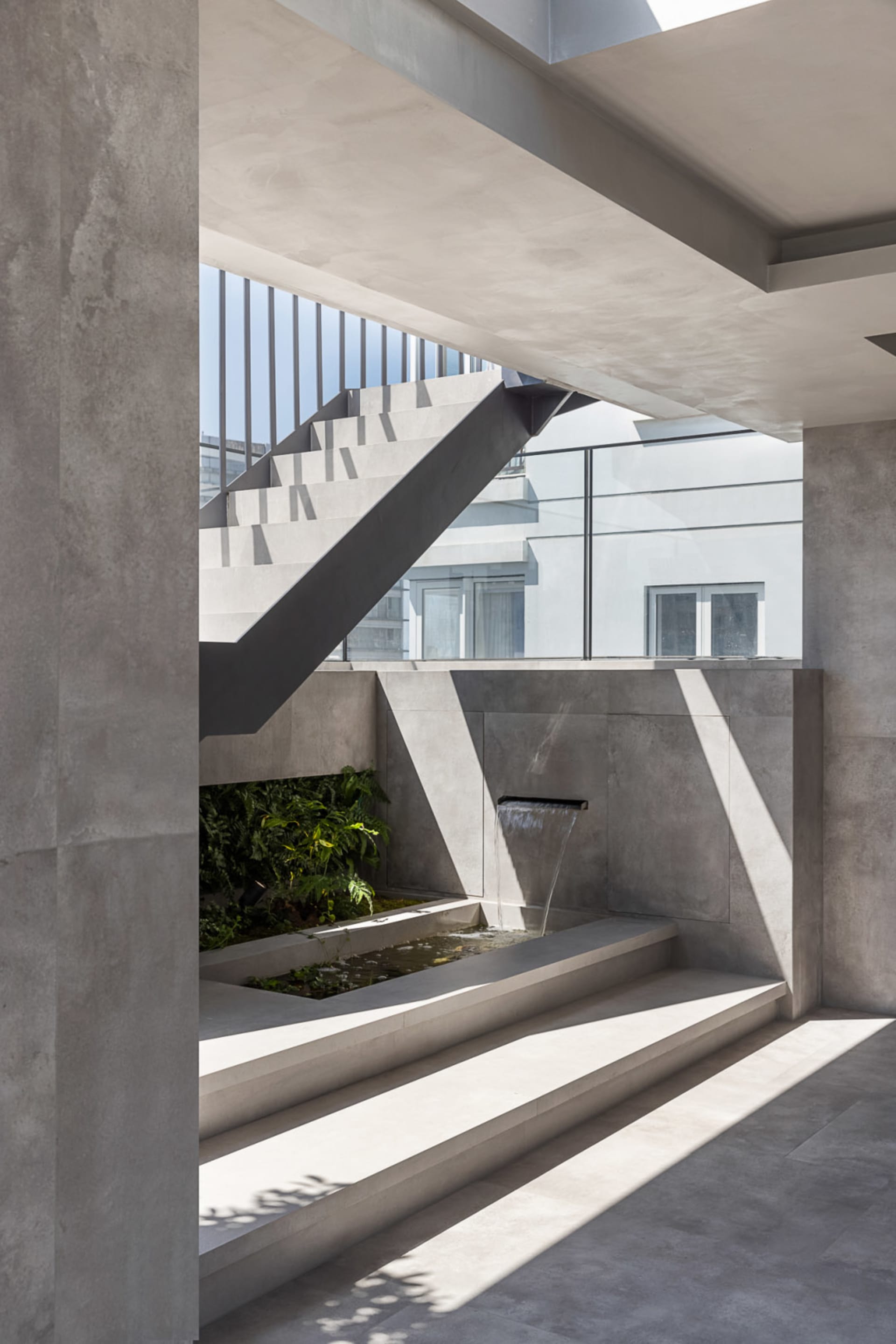 Modern indoor architecture featuring minimalist design and concrete materials.