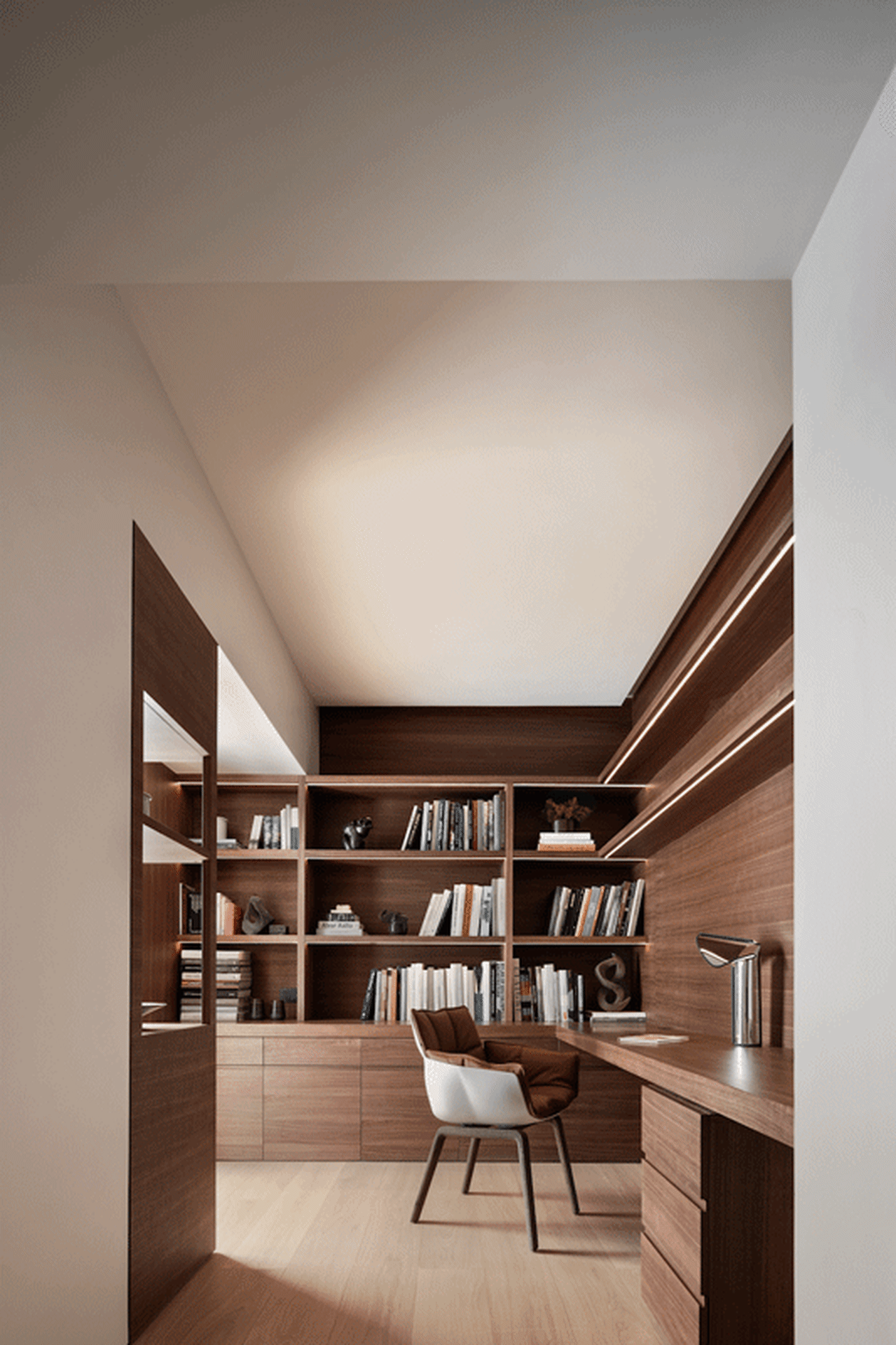 A modern study with a wooden shelf system, featuring a desk, chair, and books.