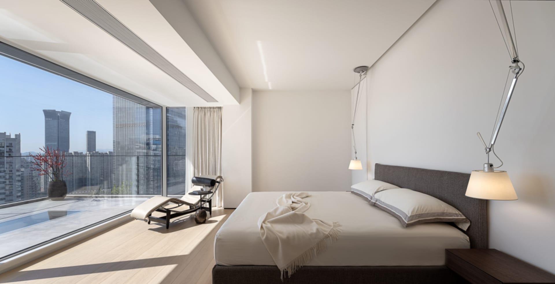 Modern interior design featuring glass windows and wooden flooring.