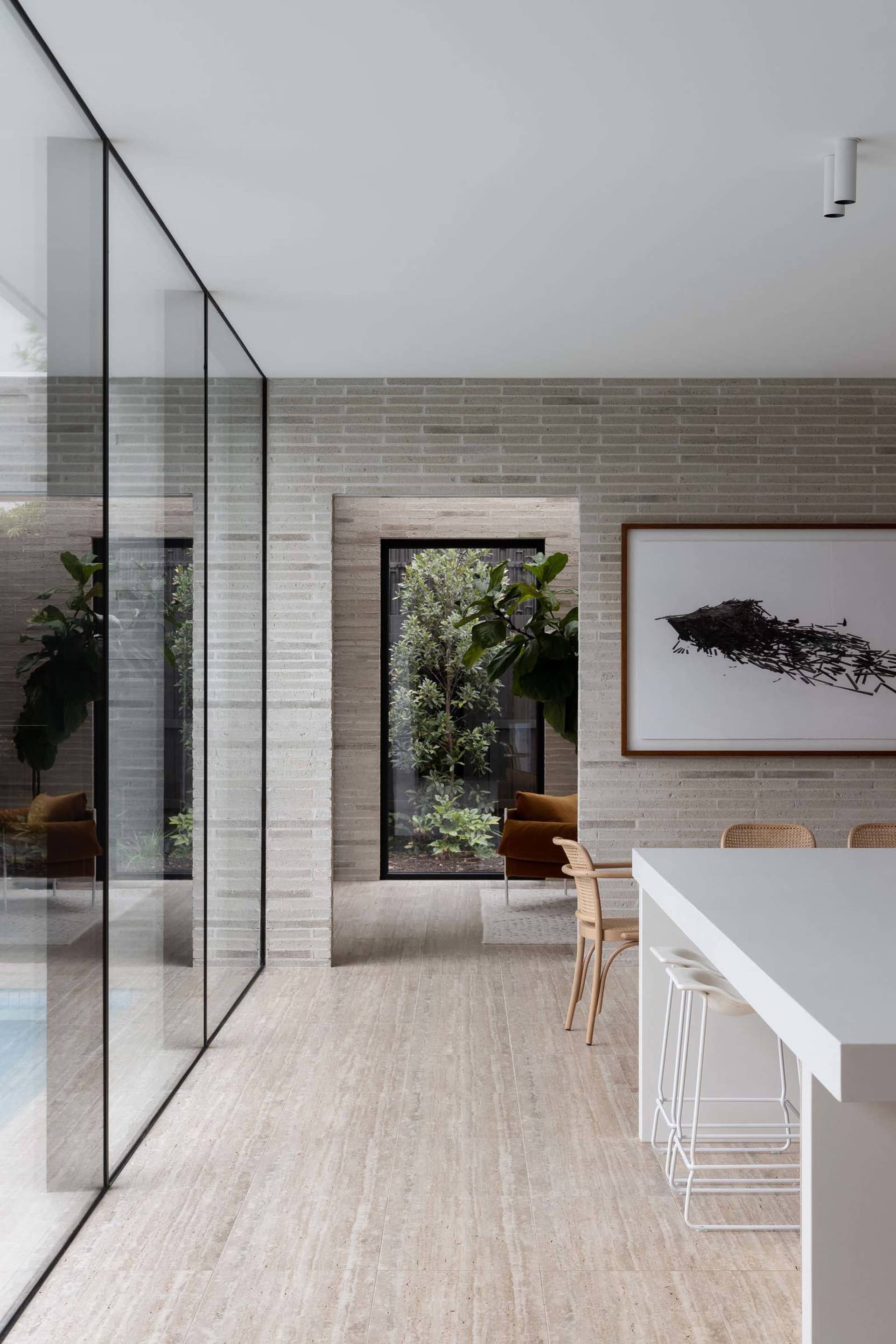 Modern interior with concrete walls, glass walls, and a minimalist design