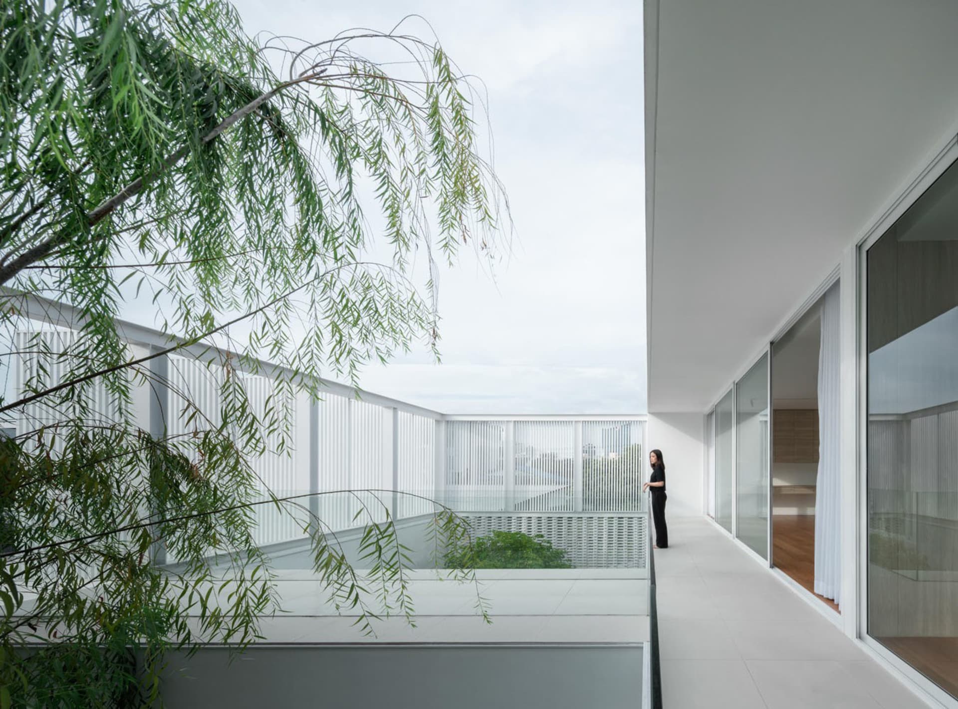 Modern high-rise living room with large window frame and white tile flooring