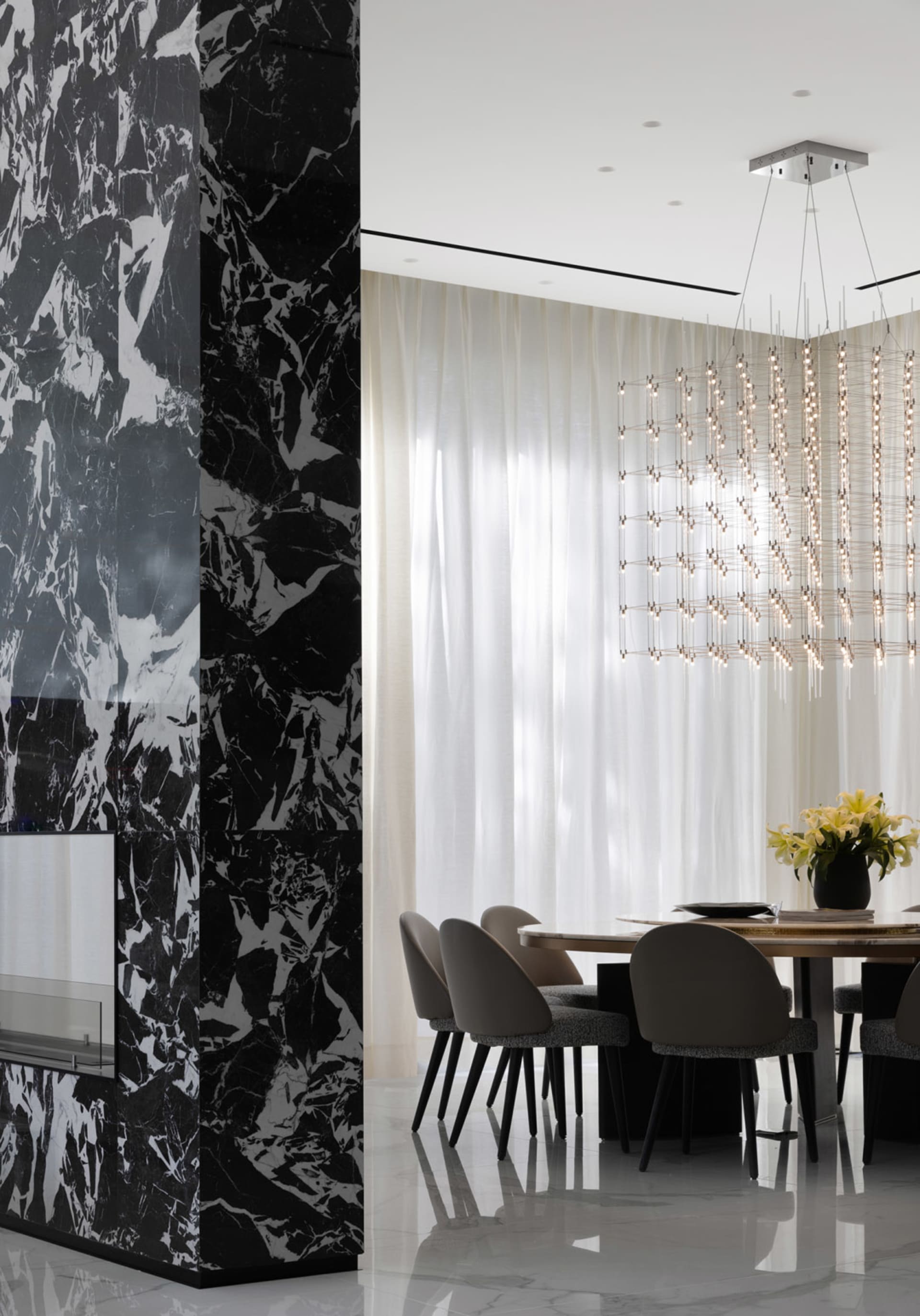 Modern dining room featuring marble accents and contemporary design elements.