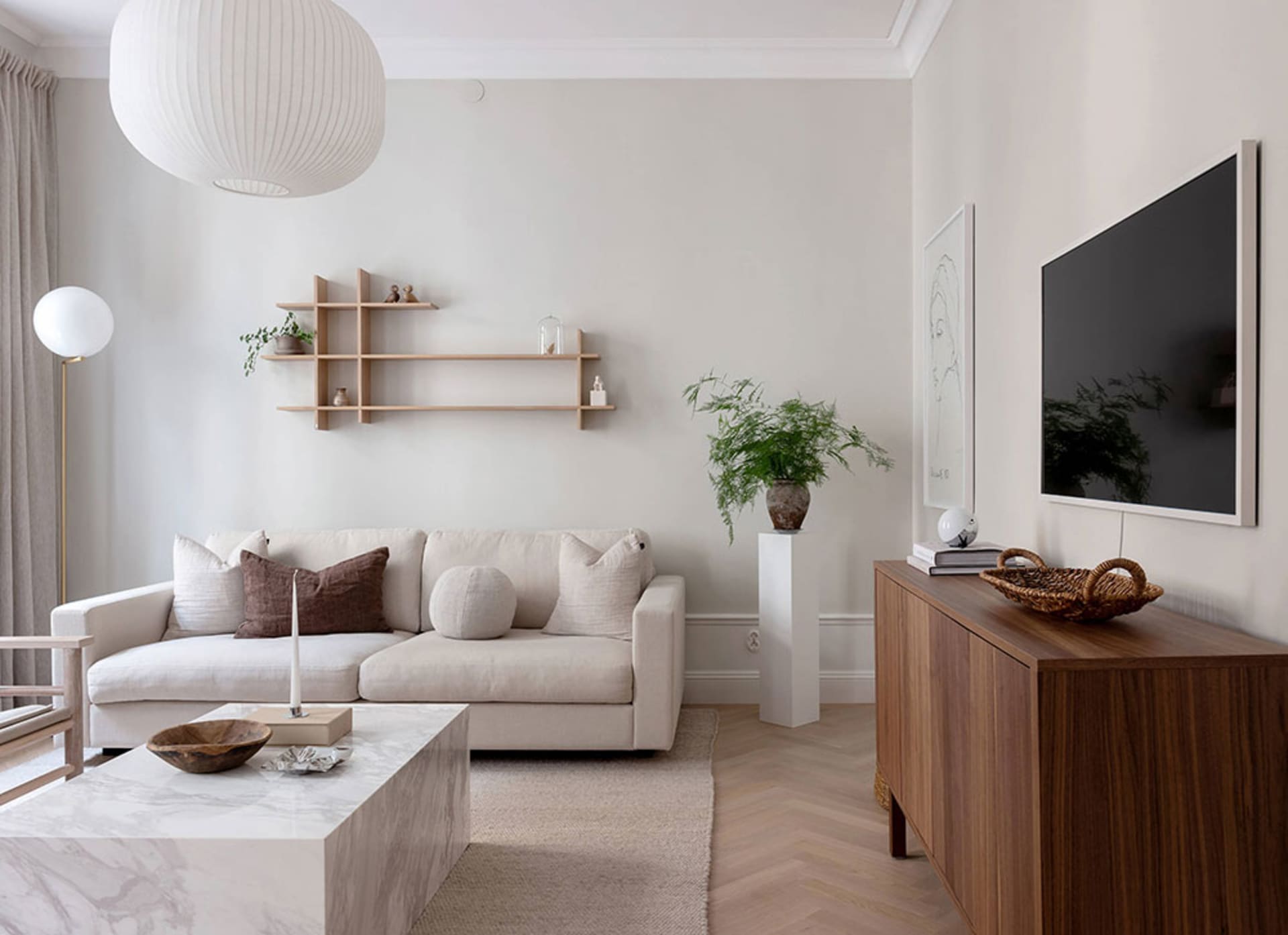 A minimalist living room featuring marble and wooden elements.