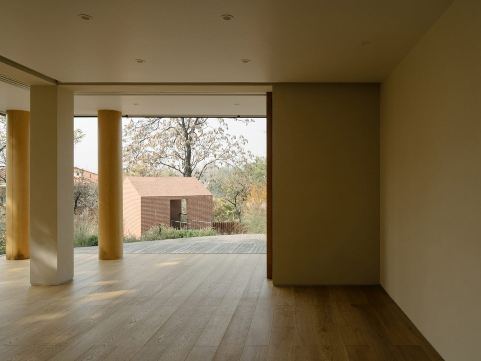 A modern residential interior showcasing wood flooring and natural light.