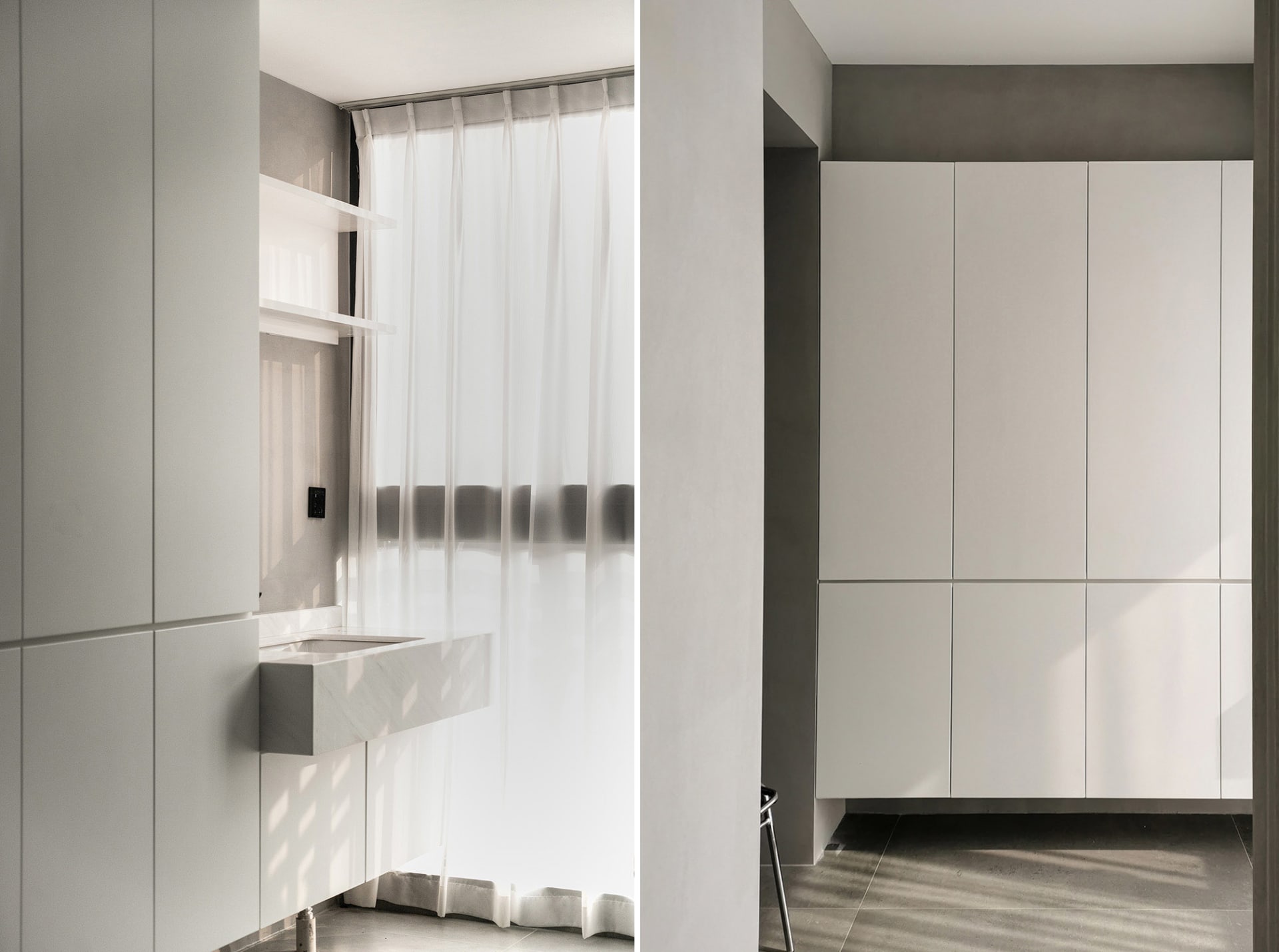 Minimalist kitchen interior with concrete walls and floor, featuring white sheer curtains and a floating vanity.