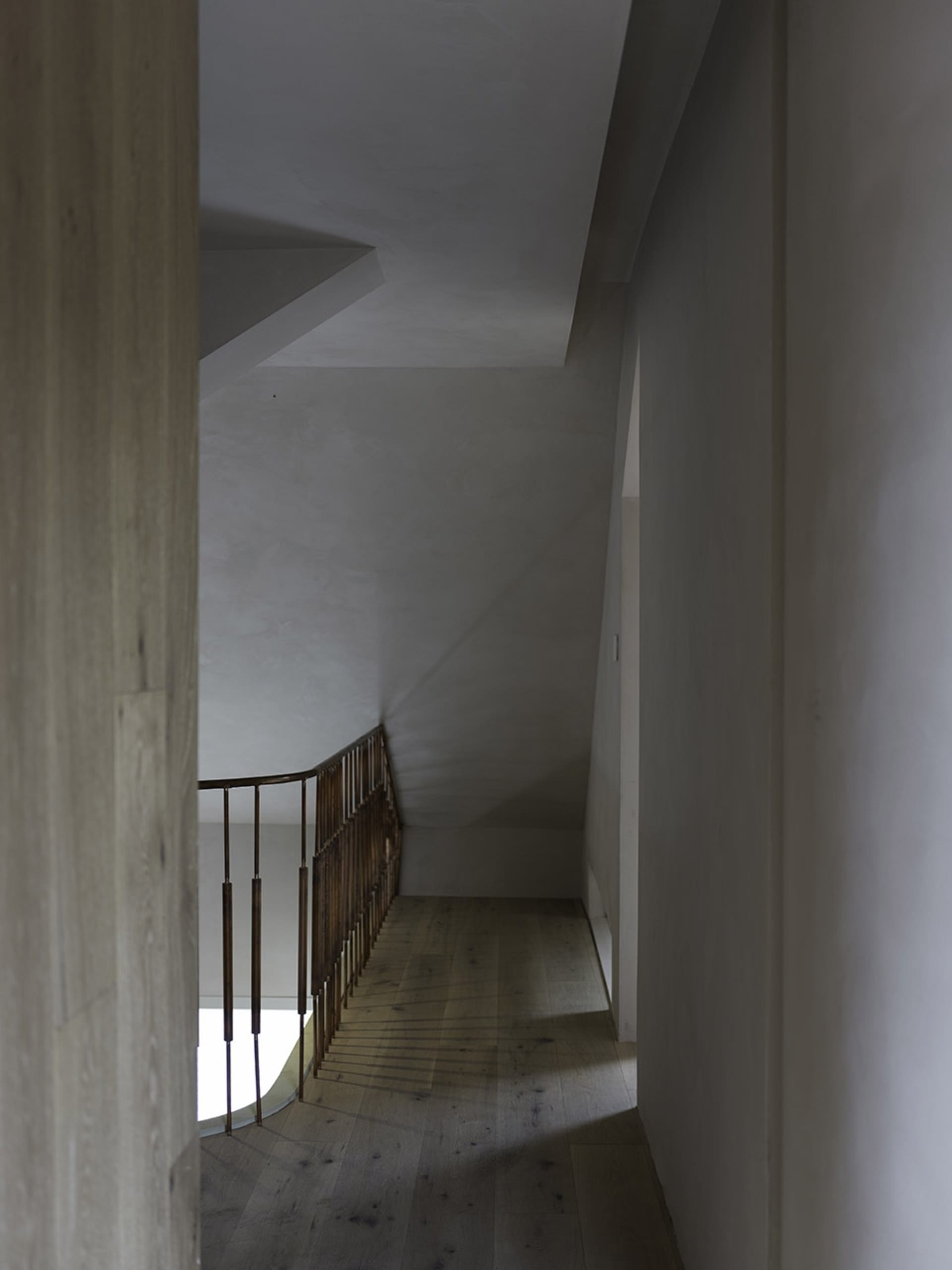 Modern, industrial-style staircase featuring wood flooring and metal railings.