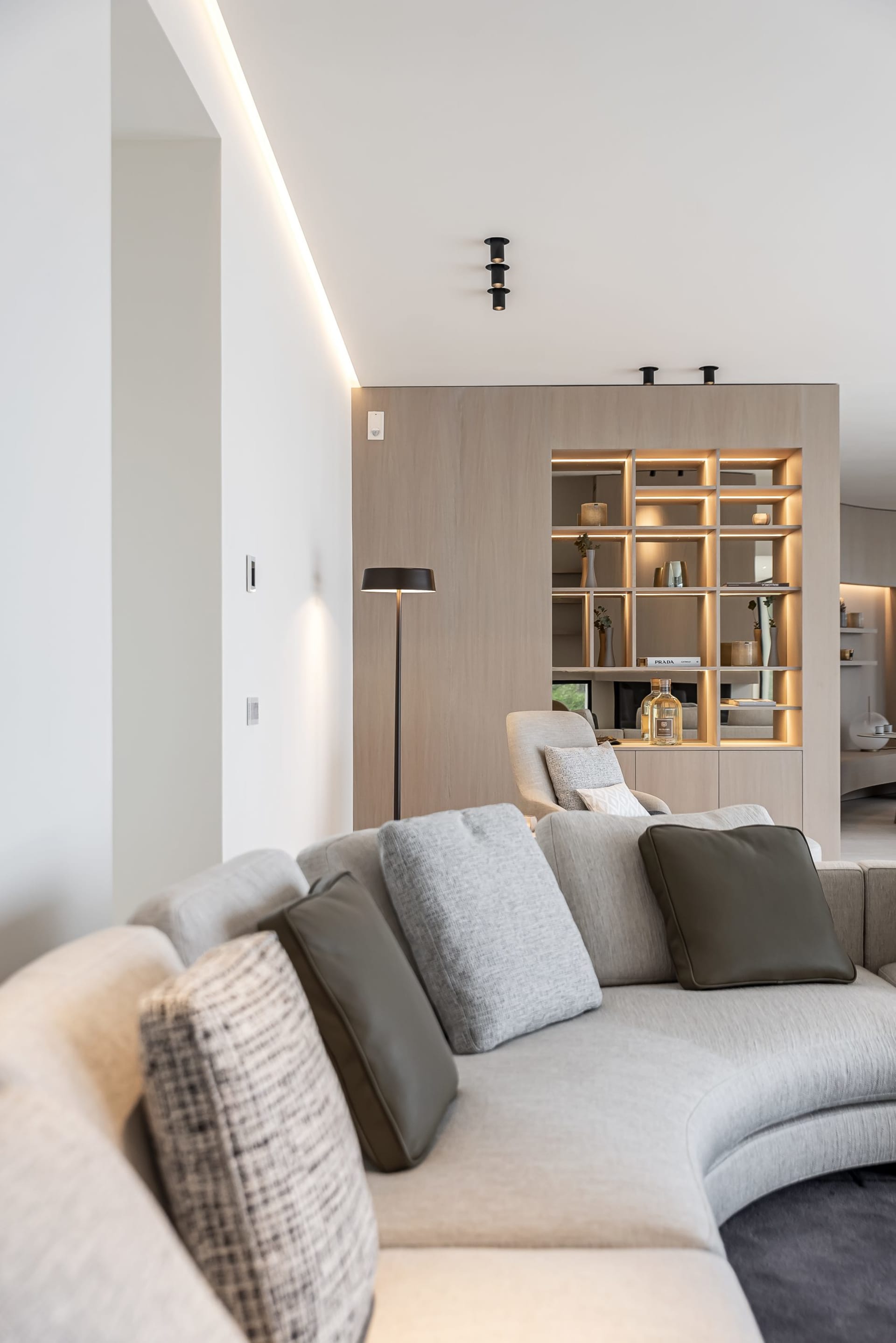 A modern living room with neutral-toned furnishings and minimalist decor.