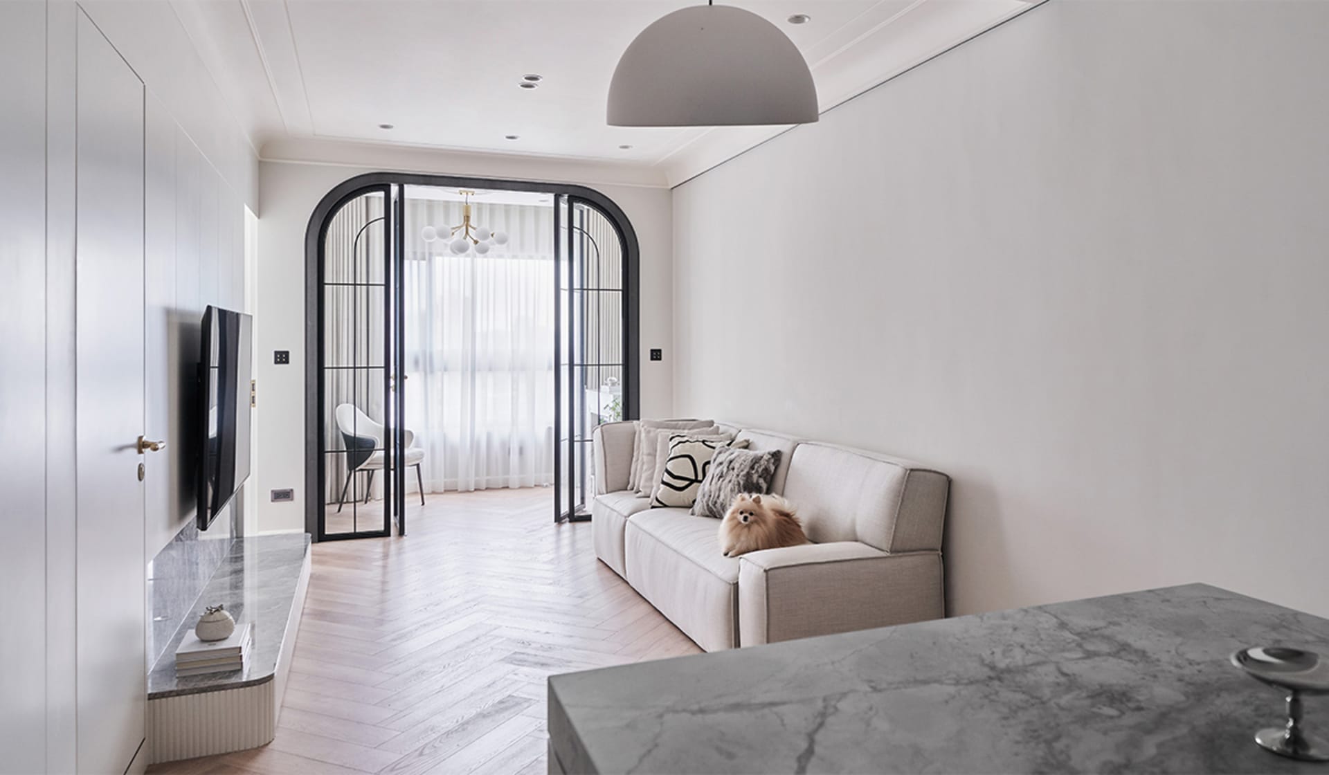 A modern living room featuring neutral tones and minimalist furniture.