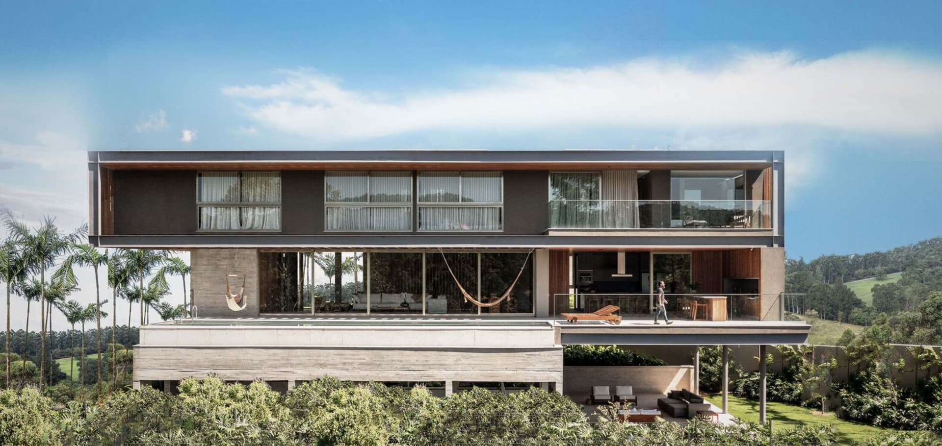 Modern residential exterior with wood, concrete, and glass materials.