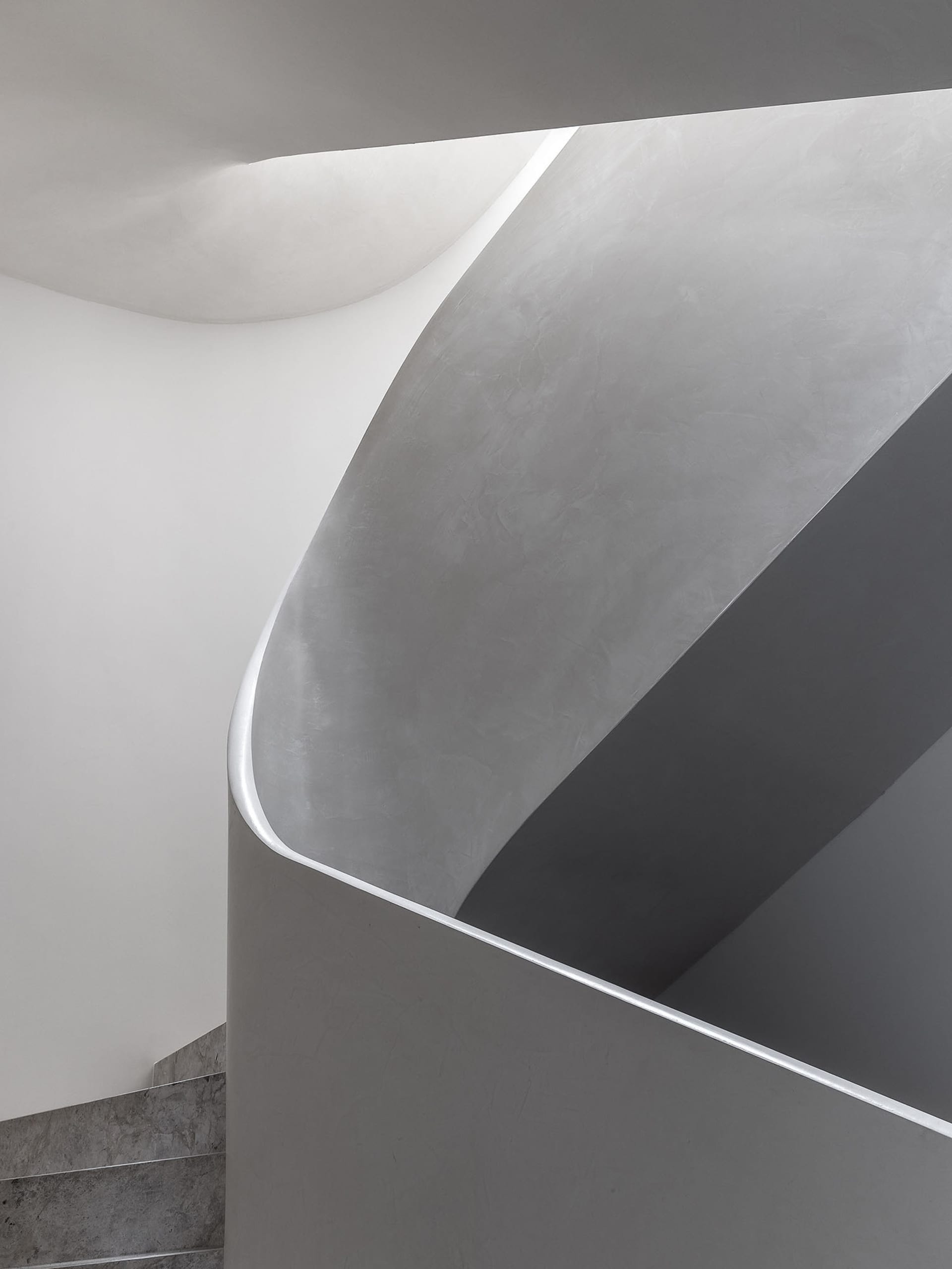 Grey concrete spiral staircase with minimalist design