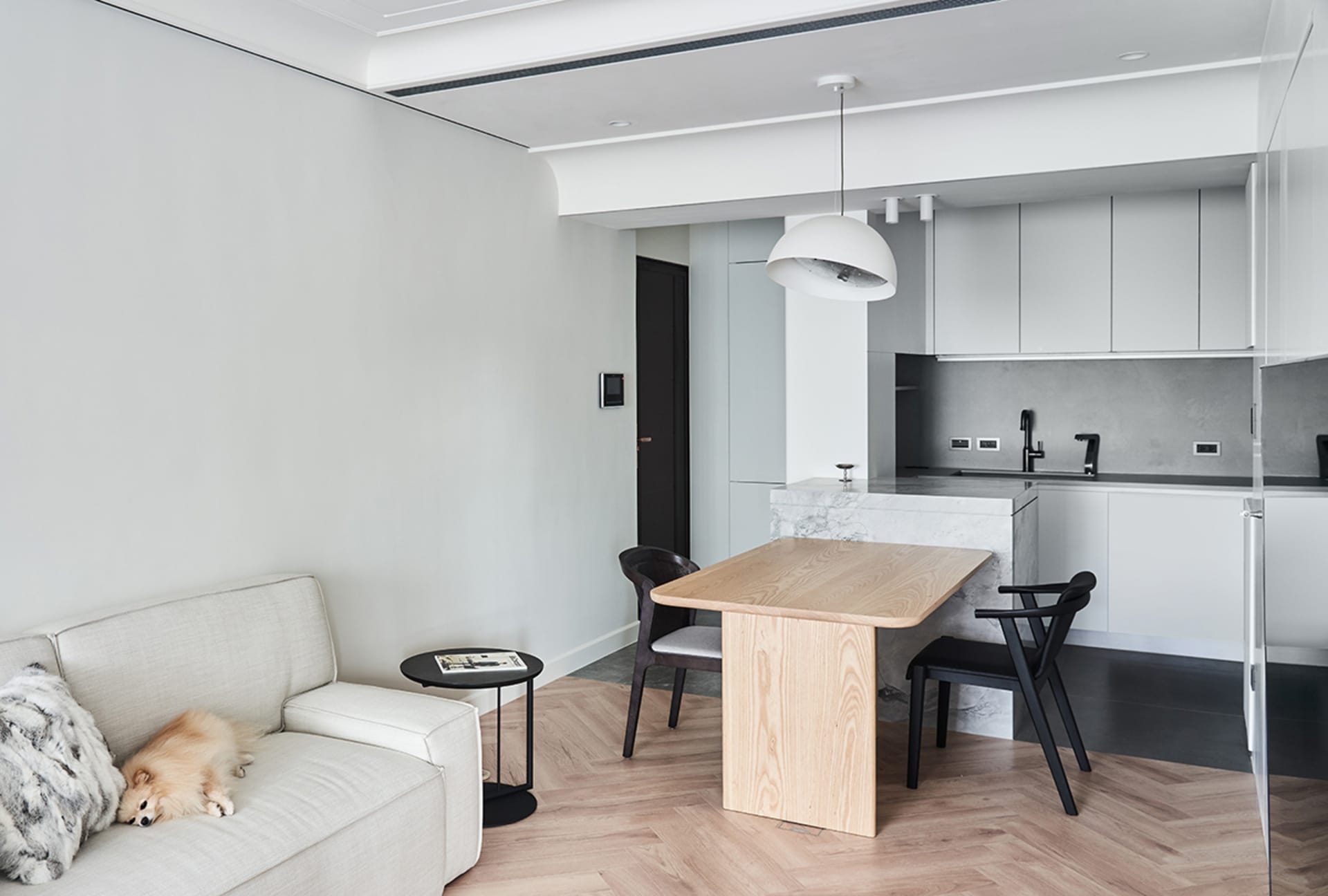 A modern interior space featuring white walls, flooring, and furniture.