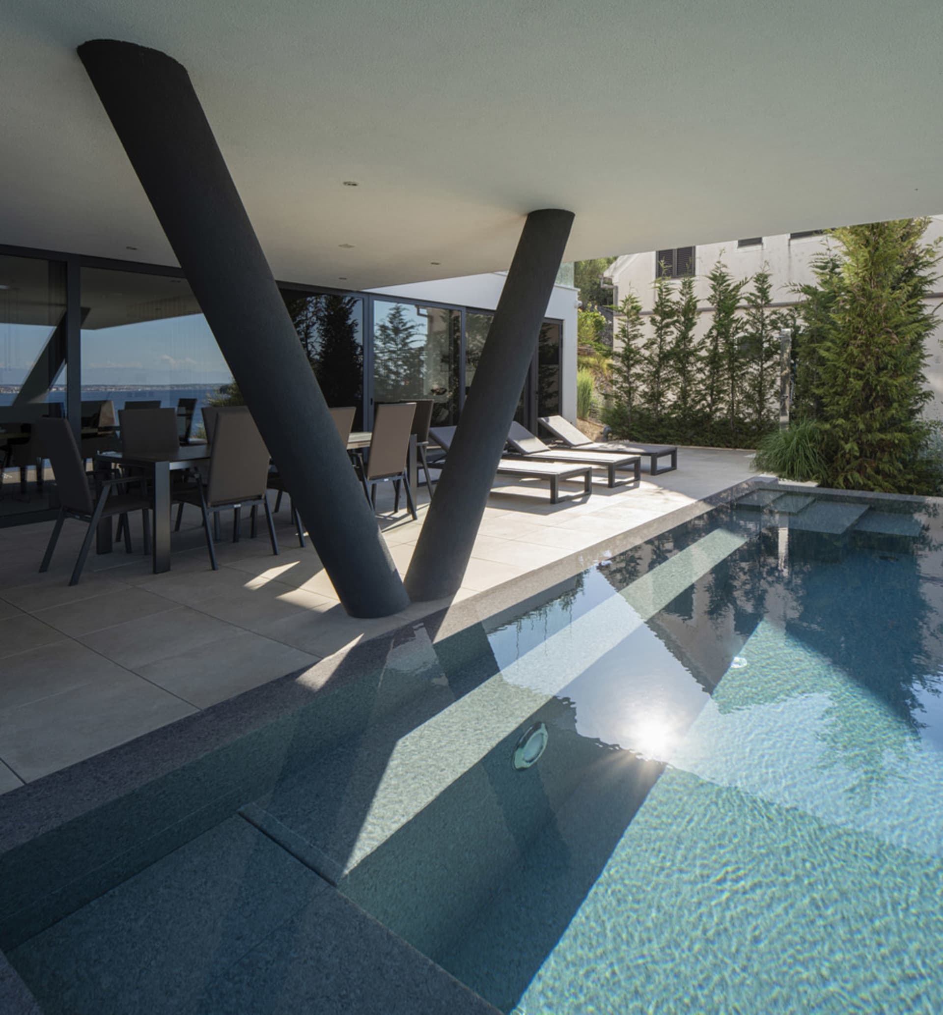 A modern pool designed with concrete walls, featuring clean lines and sleek design.
