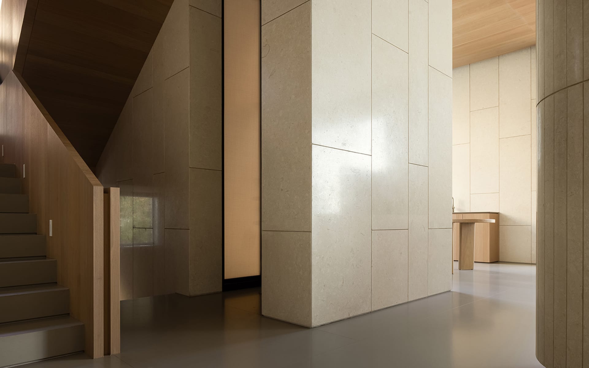 Modern minimalist interior design with walnut and marble flooring, showcasing sleek lines and natural materials.