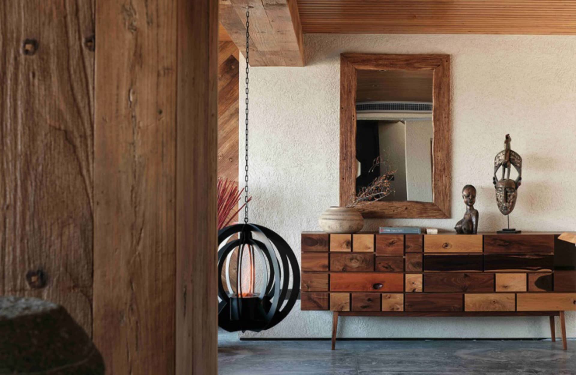 A modern living room with furniture made of wood, including a wooden sideboard with a vase and a hanging lamp.
