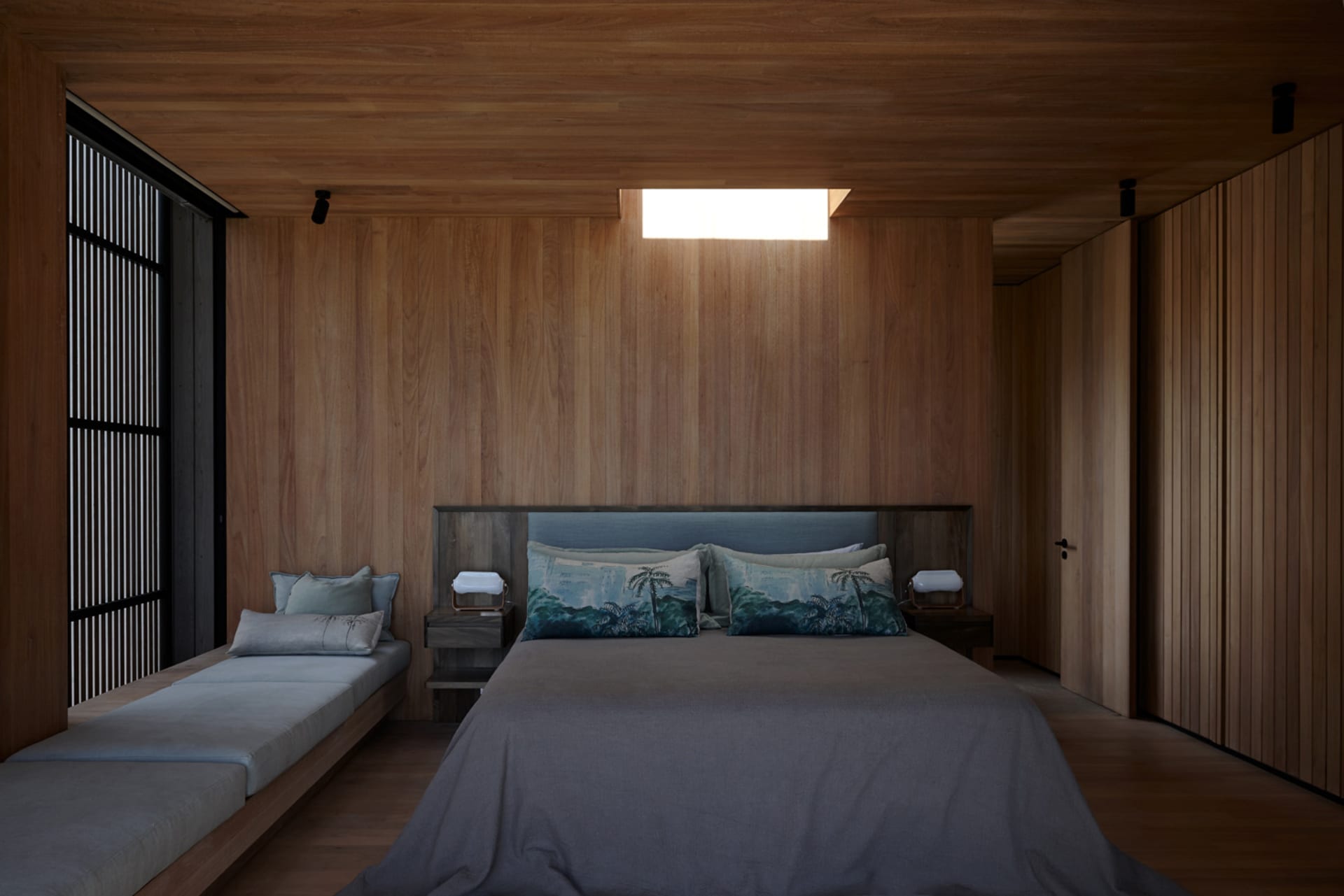A minimalist bedroom with wooden paneling, a large bed, and a window with wooden blinds.