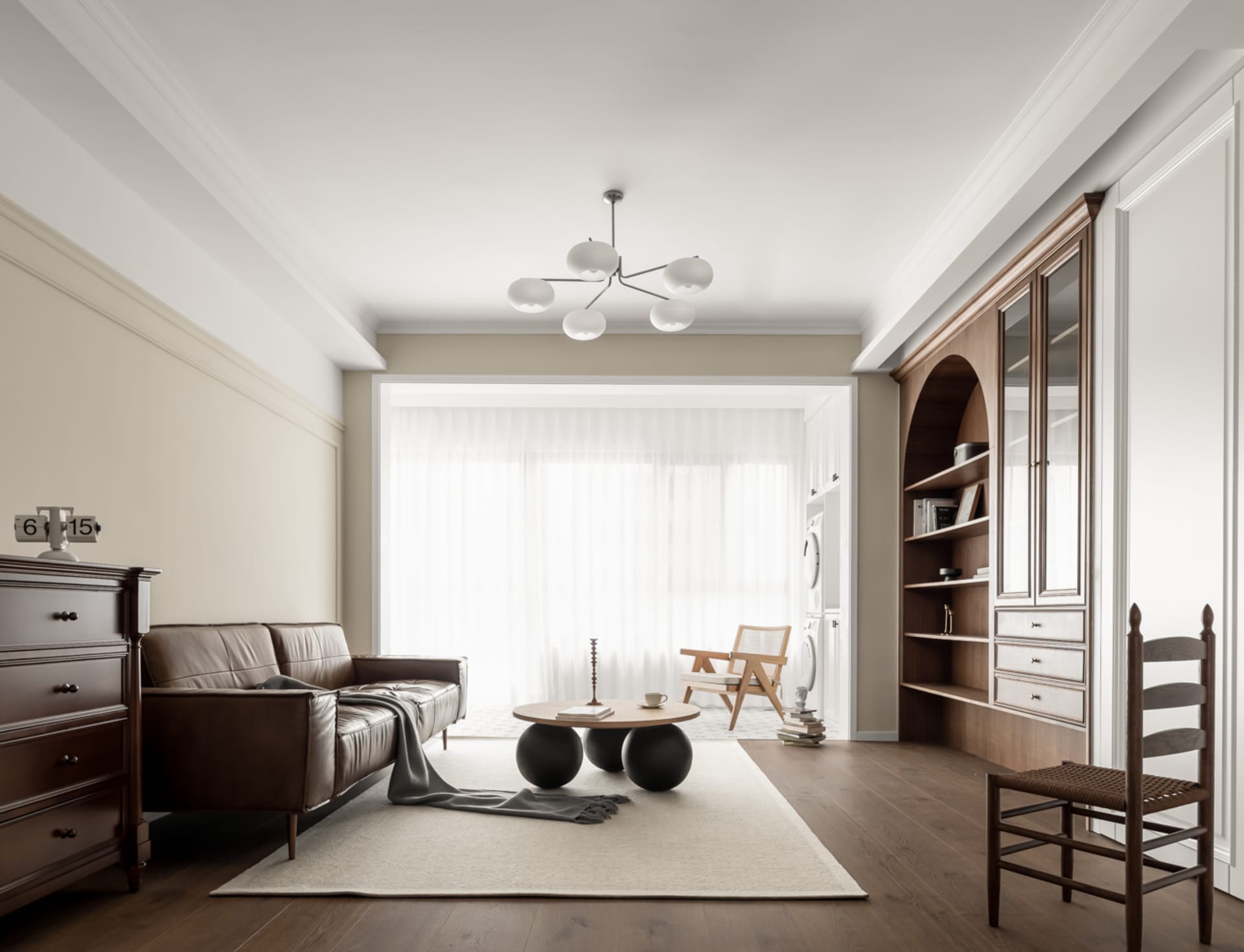 A minimalist living room with a leather sofa, wooden coffee table, and glass globe chandelier.