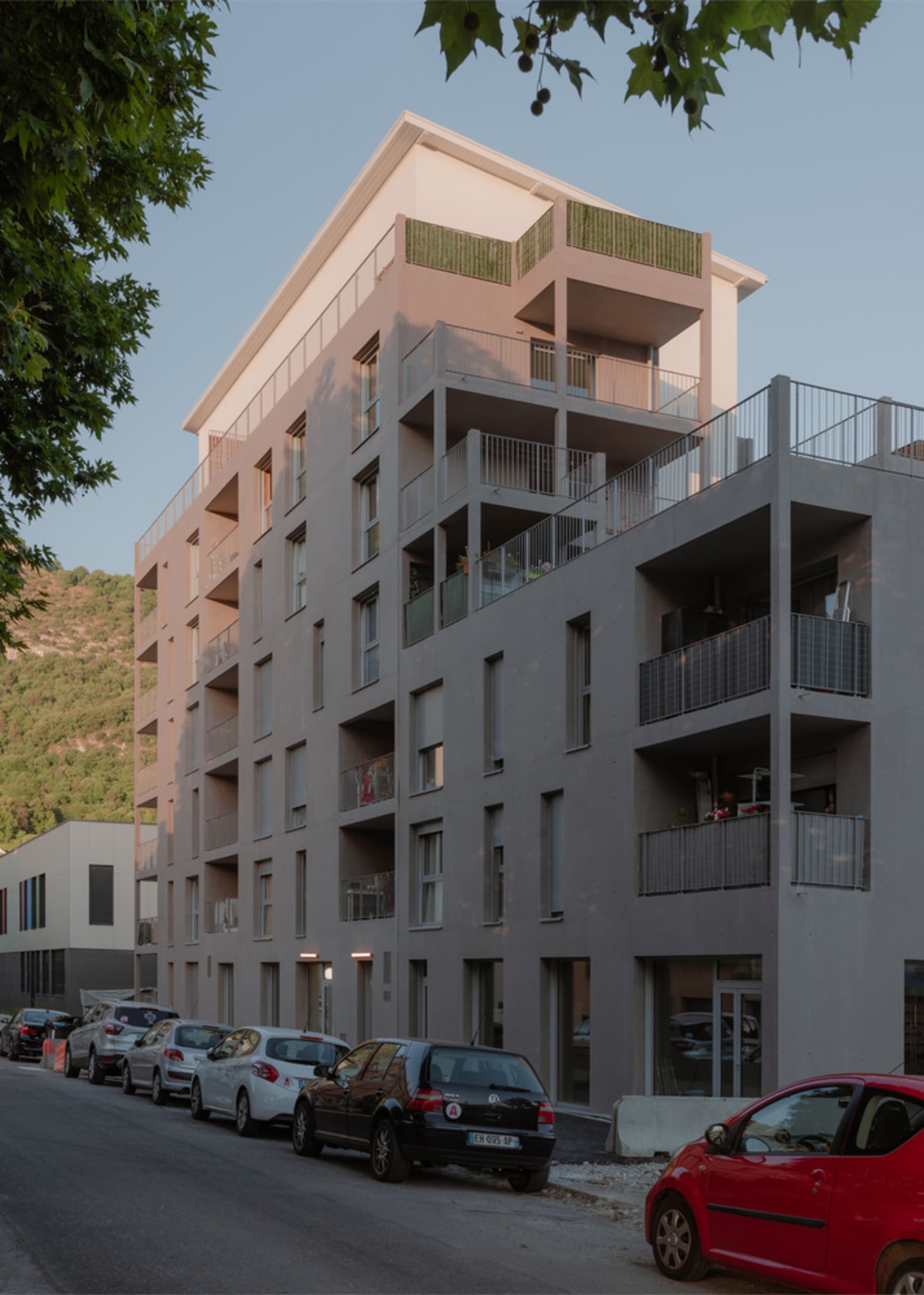 A modern apartment building with concrete and glass materials.