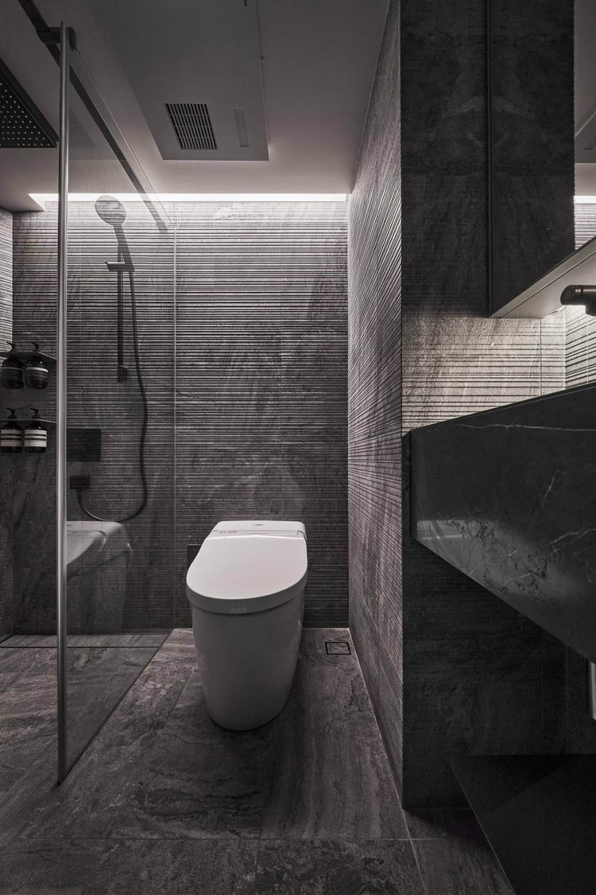 Modern bathroom featuring marble tiles and fixtures