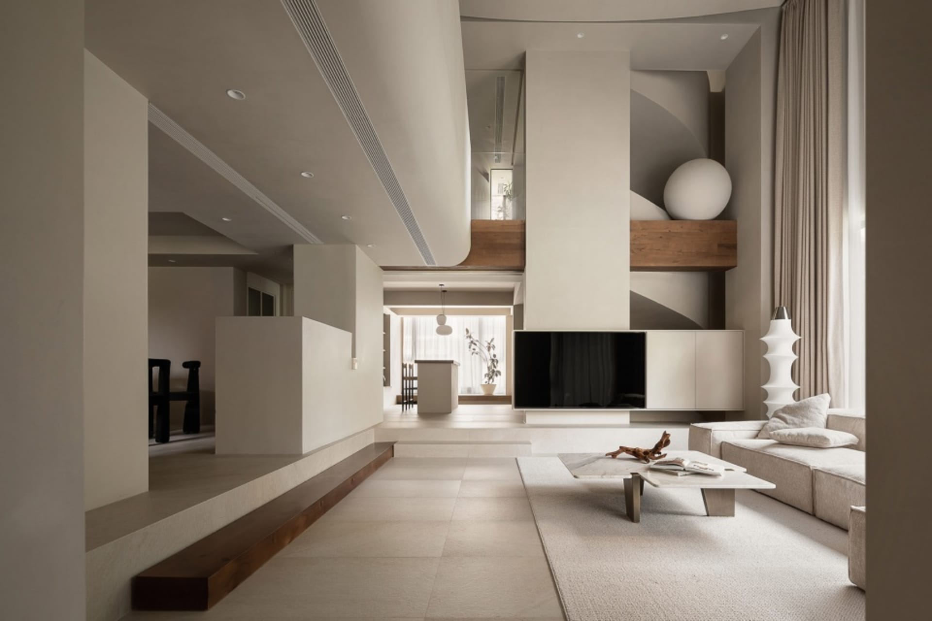 A minimalist living room with concrete texture flooring and large, open space.