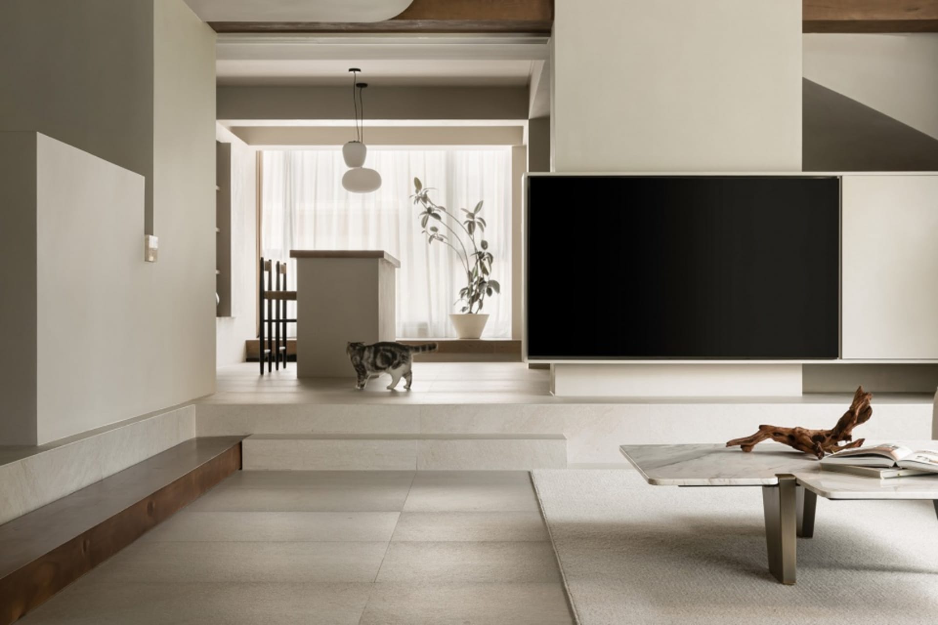 A minimalist living room with concrete and marble elements.