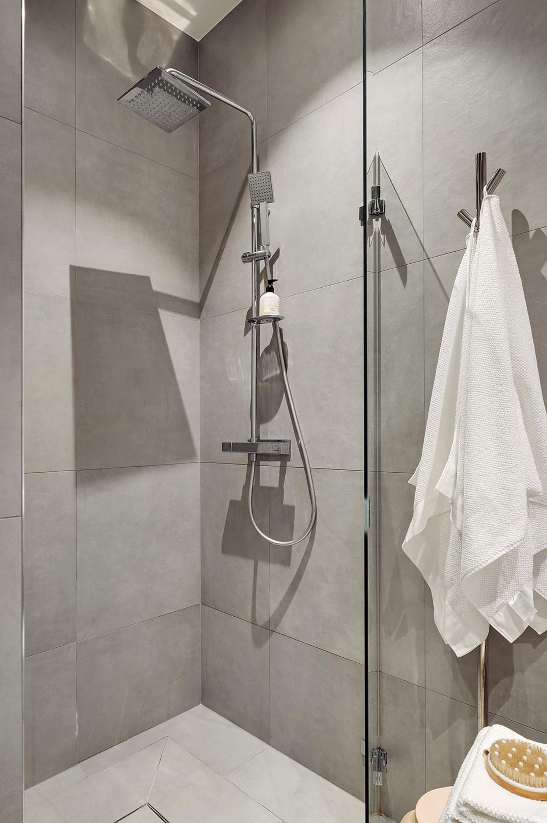 Modern bathroom featuring a concrete tile shower with a minimalist design.