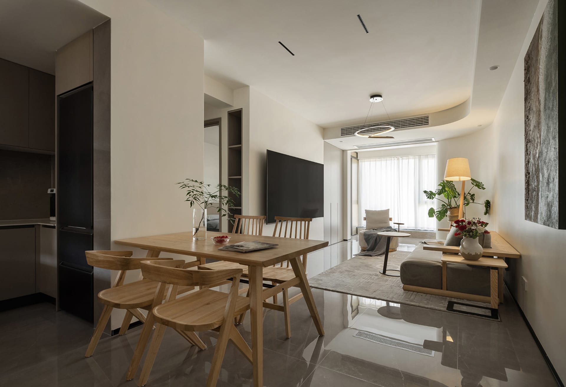 A modern residential interior featuring wooden furniture, a dining table, and living area with a cozy seating arrangement, la