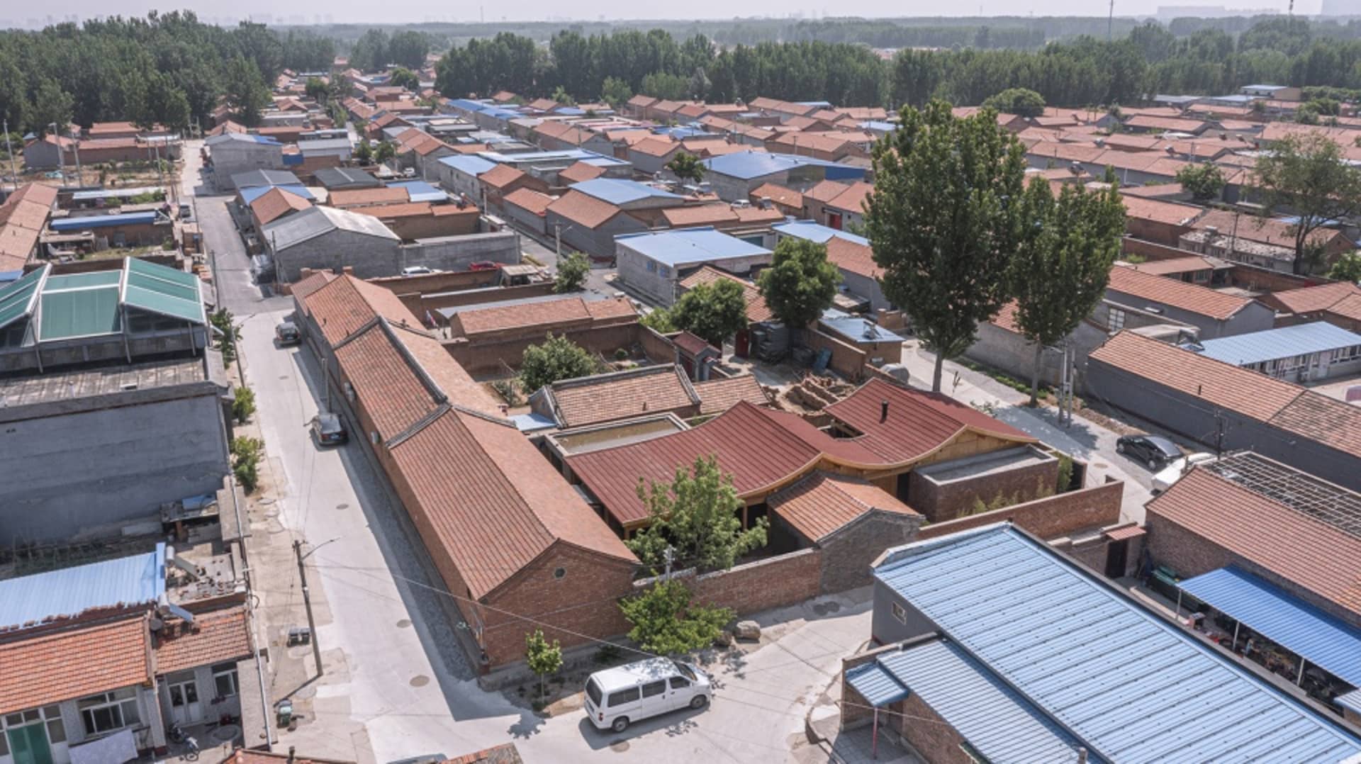 Aerial view of a residential development with brick and clay roofs.