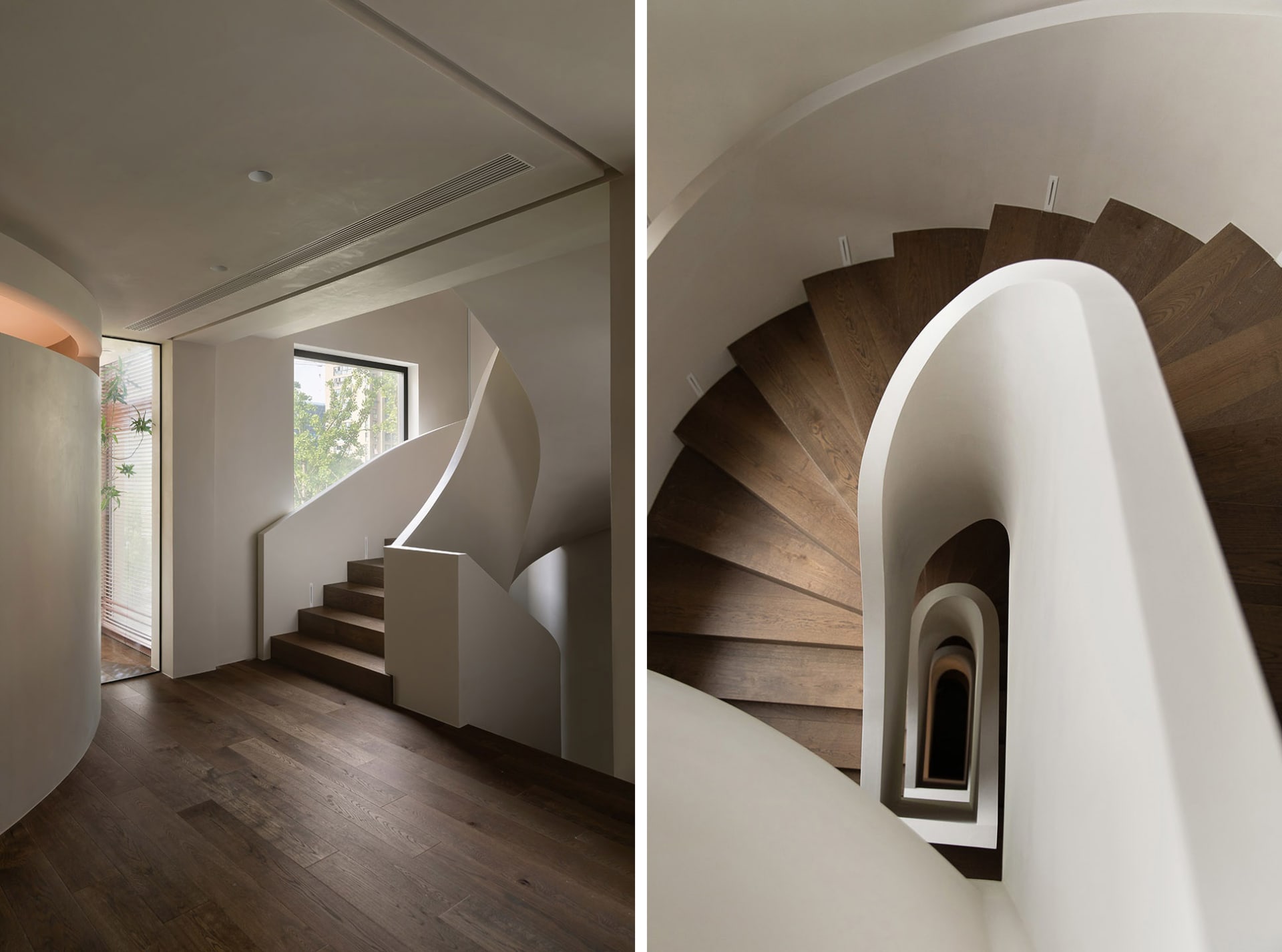 Modern minimalist staircase with curved white handrails and wooden steps, featuring natural light through a window.