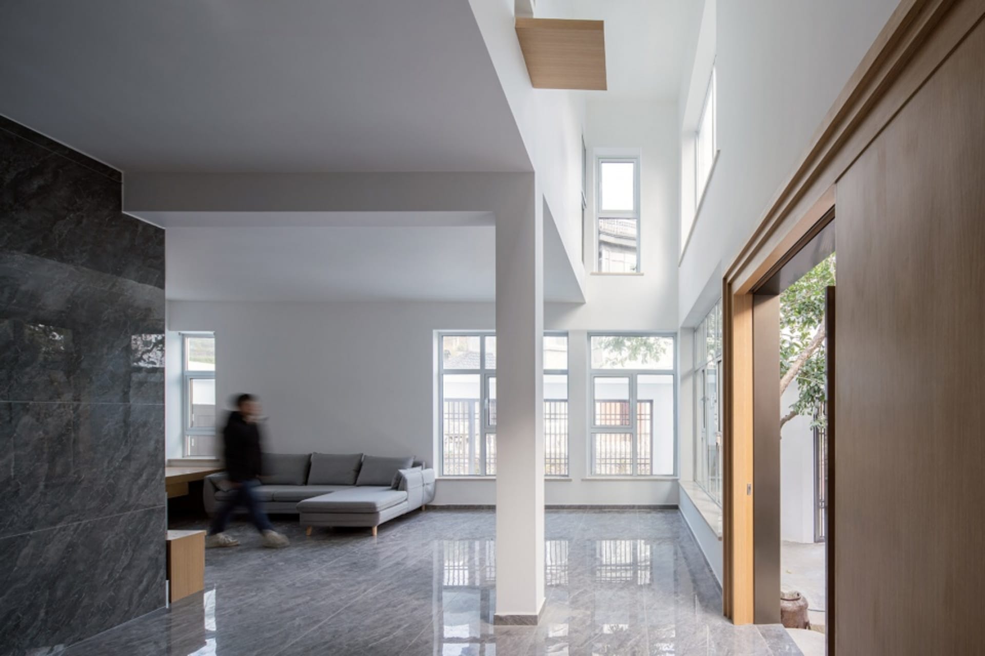A modern living room with concrete walls and floors
