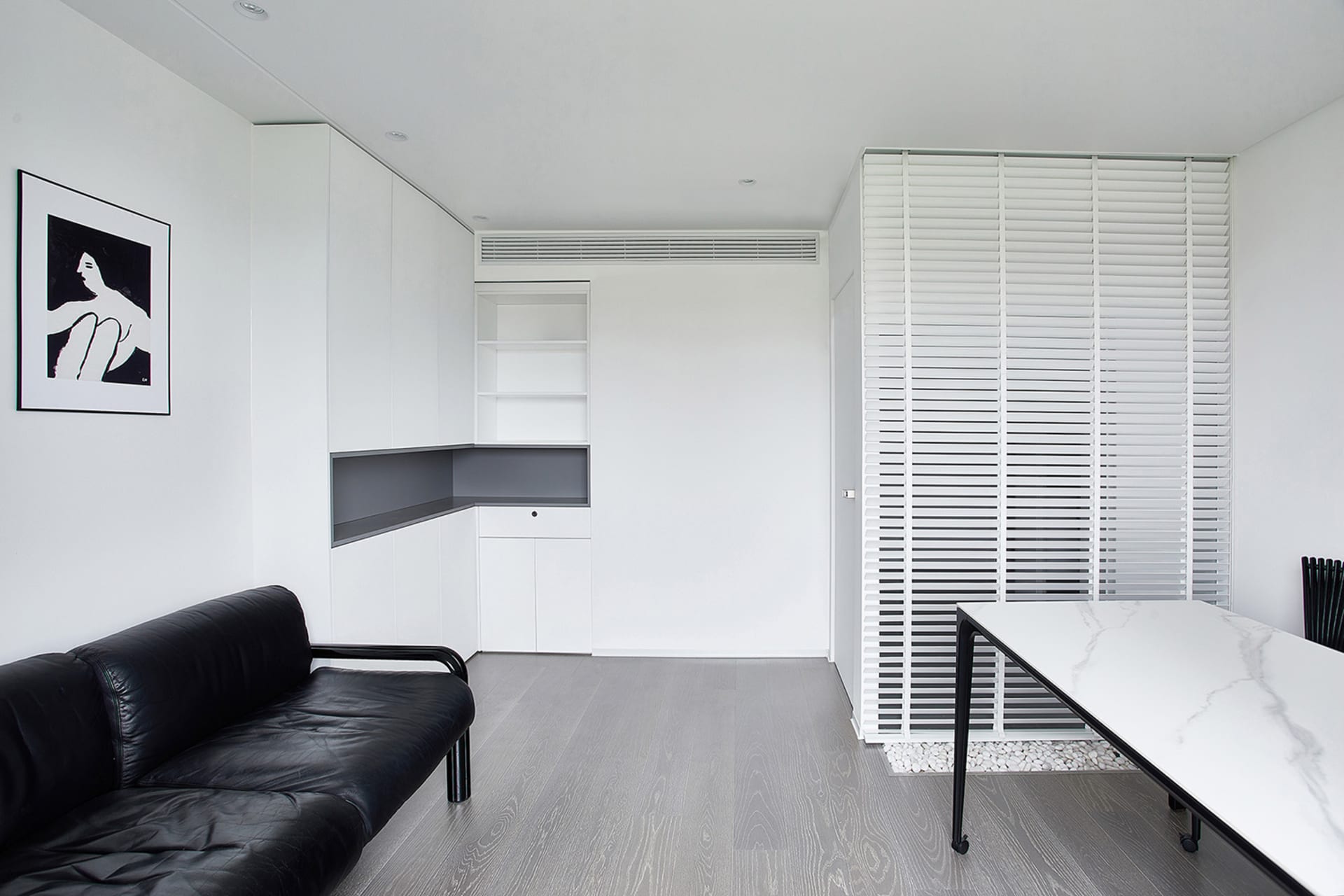 A minimalist office studio featuring marble and leather materials.