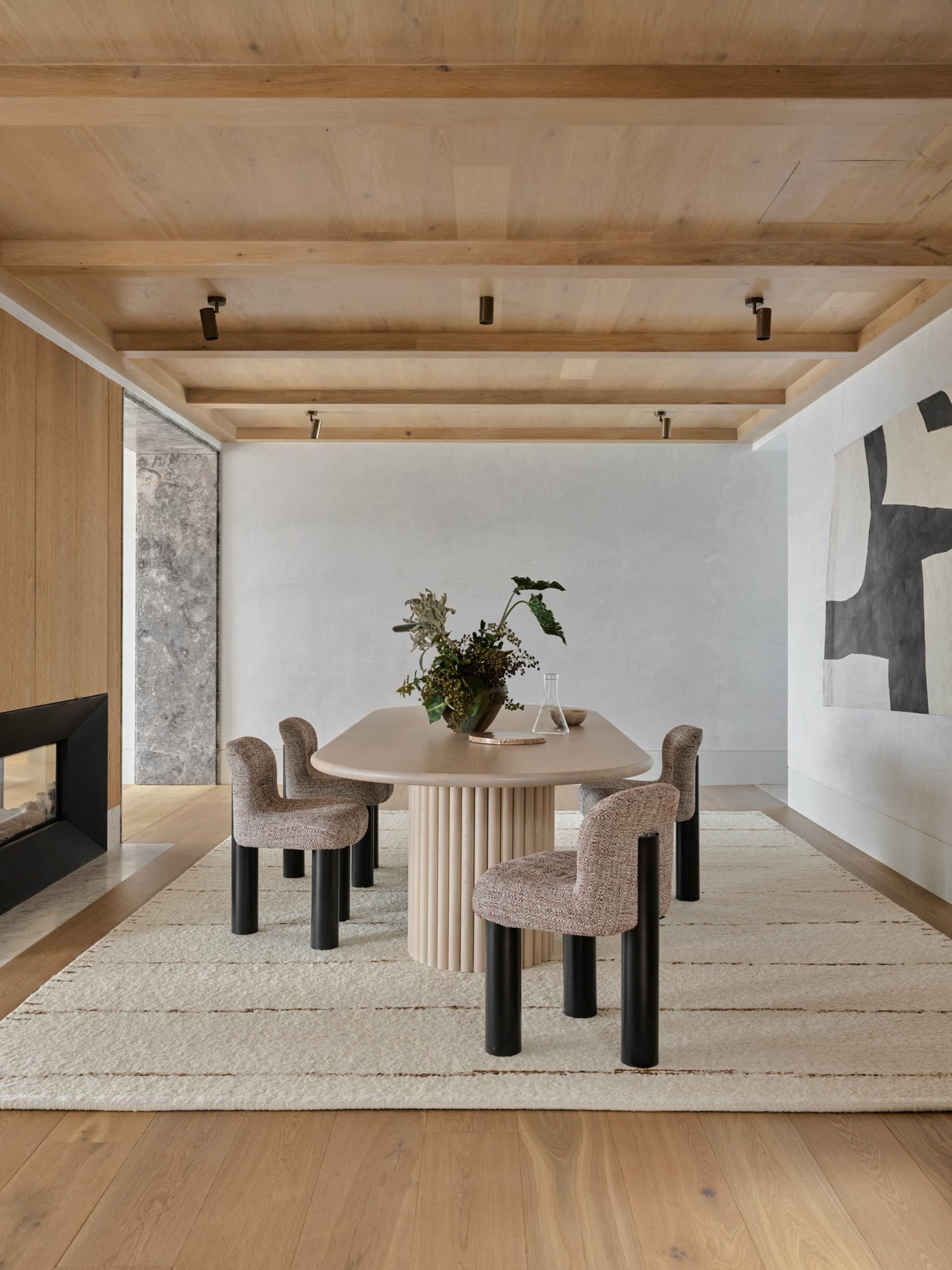 Modern dining room with a wooden table and chairs.