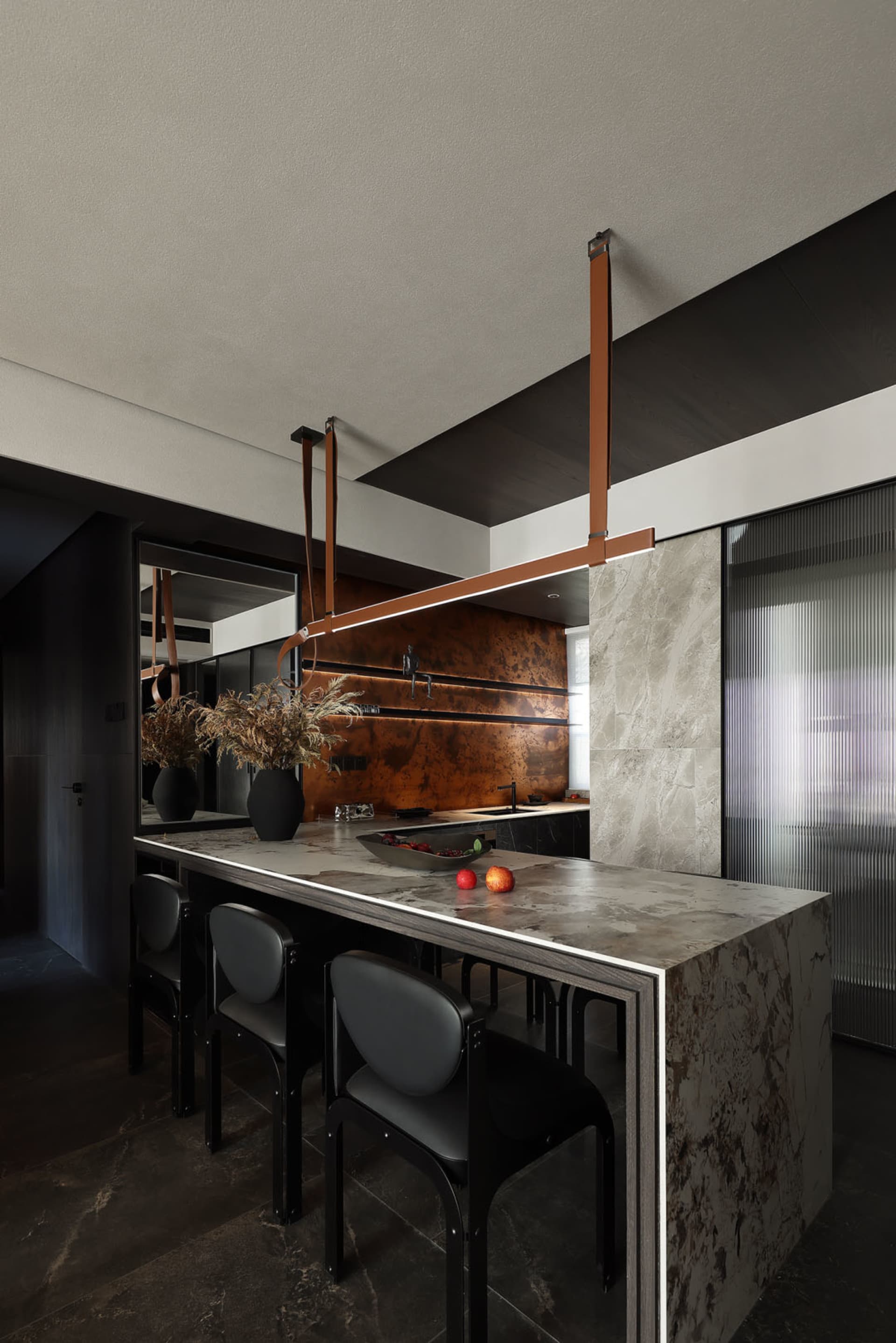 Modern kitchen featuring marble countertops and minimalist design.