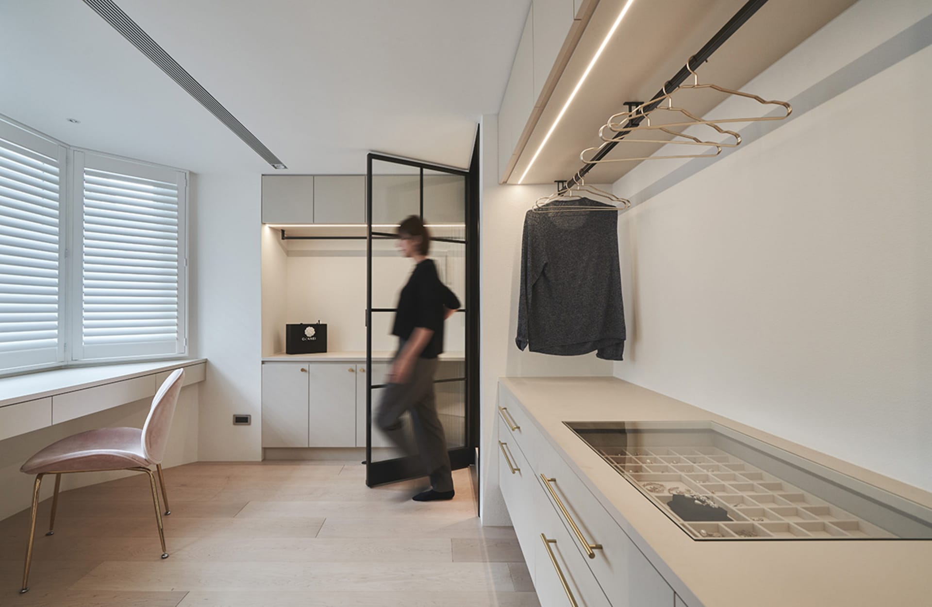 A modern wardrobe studio featuring a minimalist design with neutral materials and clean lines.