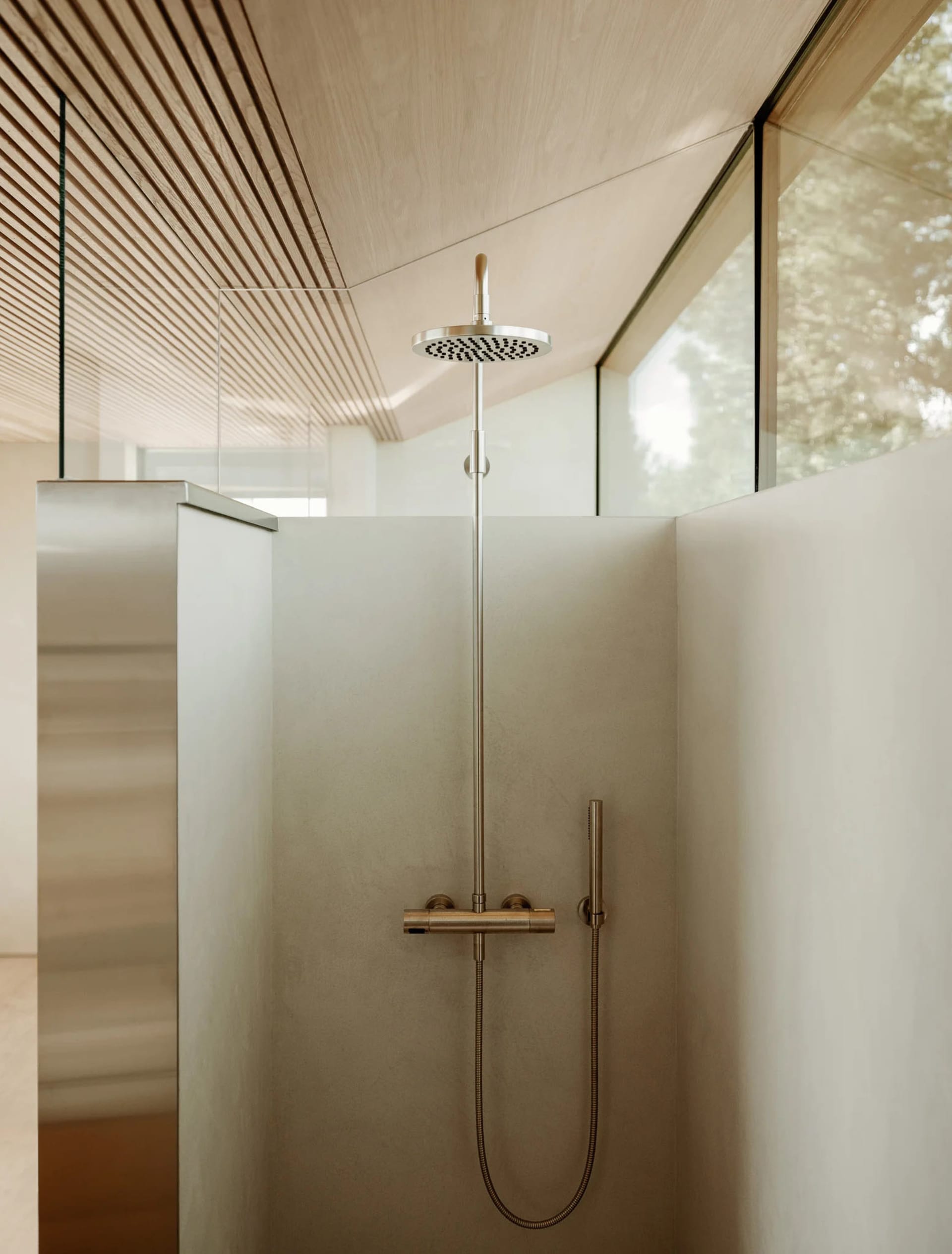 Modern bathroom with minimalist design featuring concrete walls and floor.