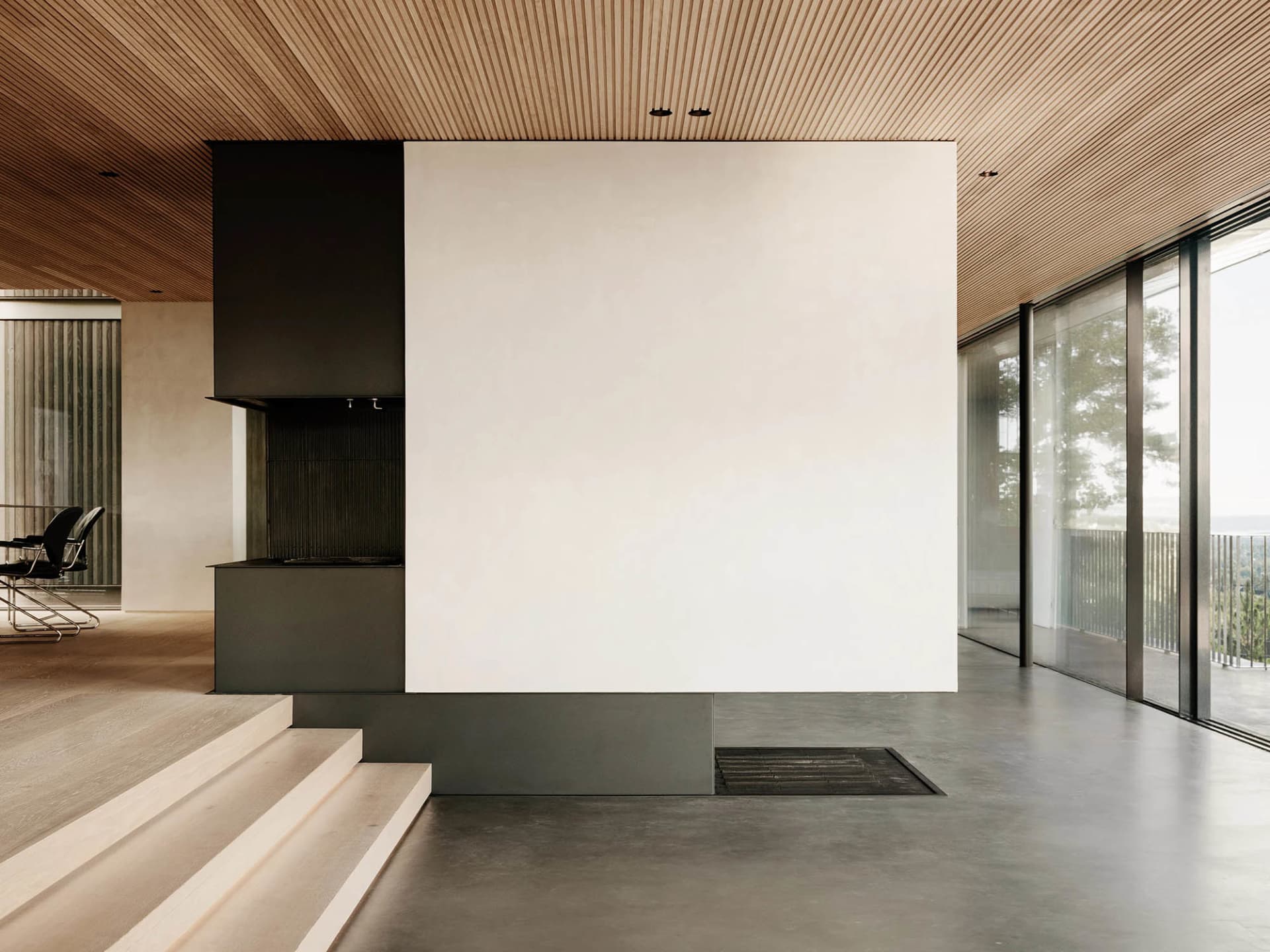 Modern minimalist living room with concrete and wood materials