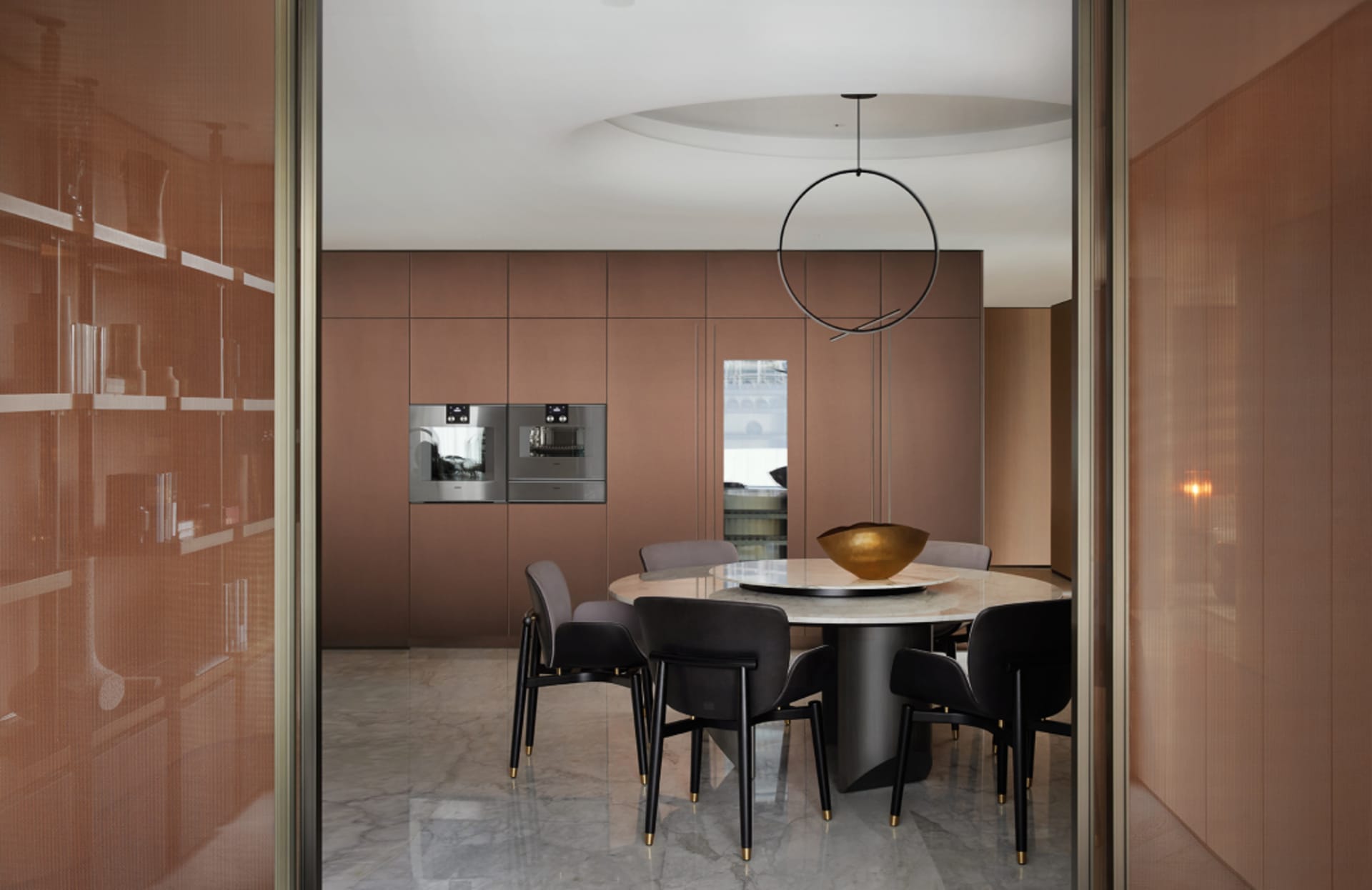 A modern dining room featuring metallic furniture and fixtures.