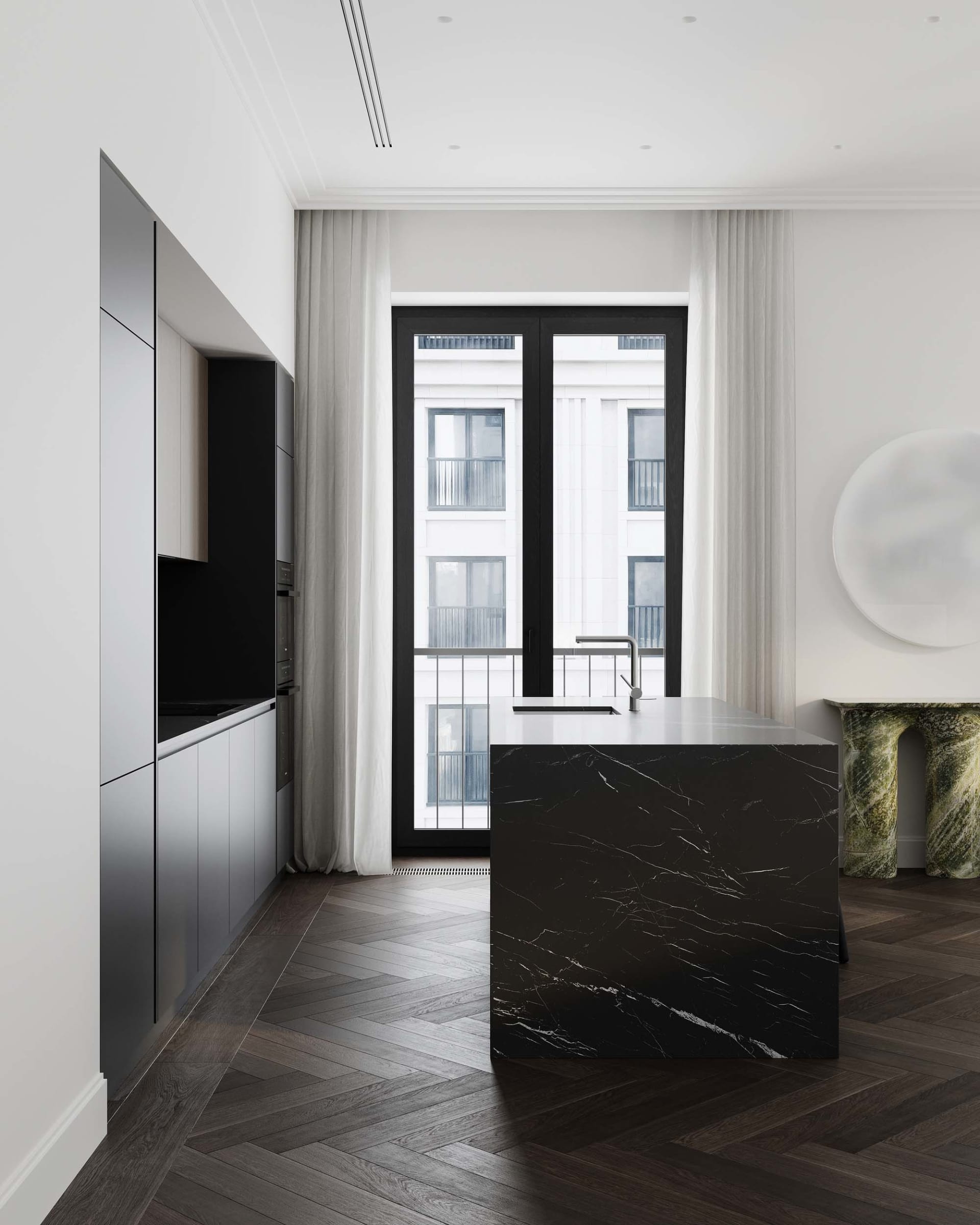 Modern kitchen featuring a black marble countertop and dark wooden flooring.