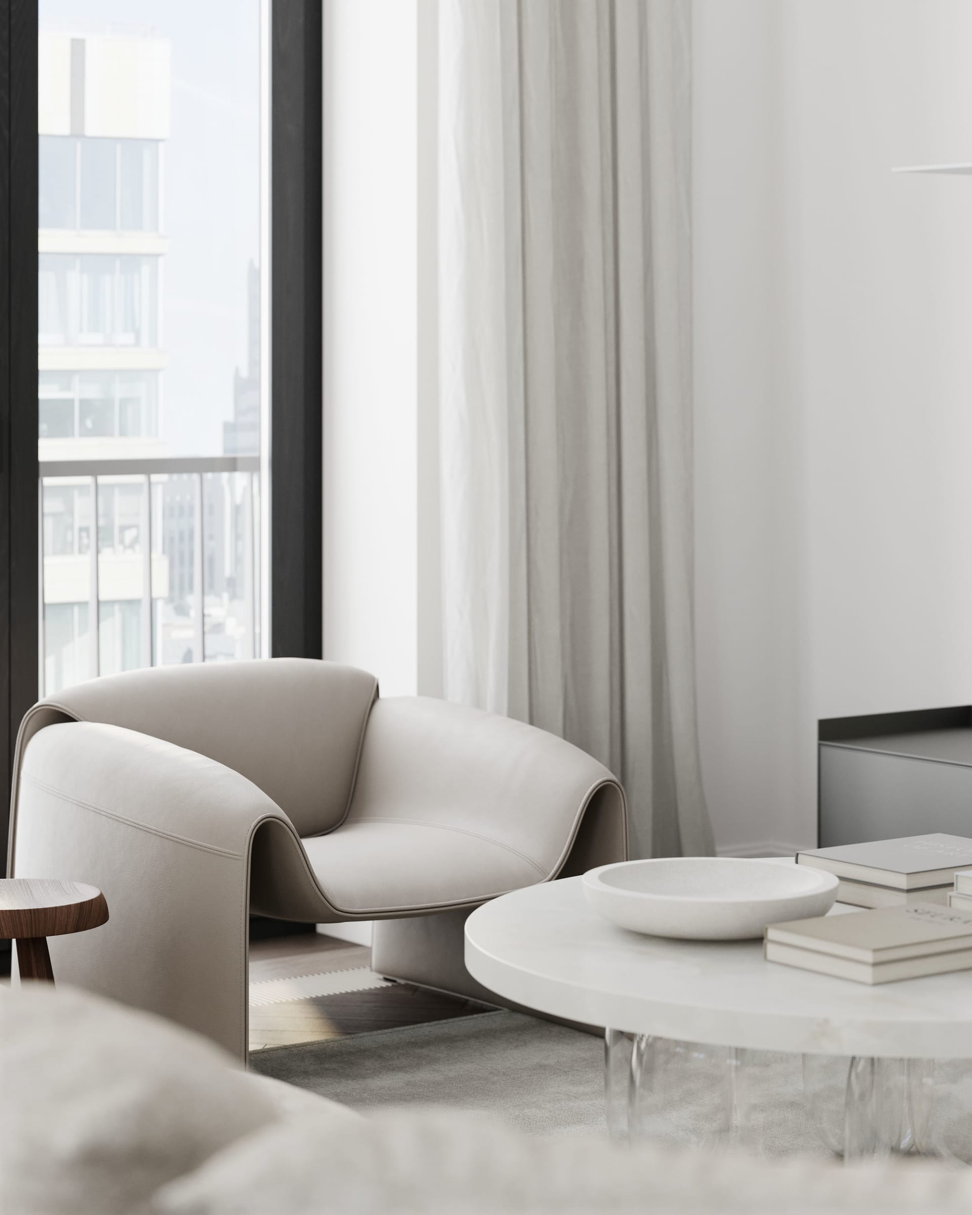 Modern living room with white fabric and leather furniture, light gray curtains, and a sleek, white round coffee table.