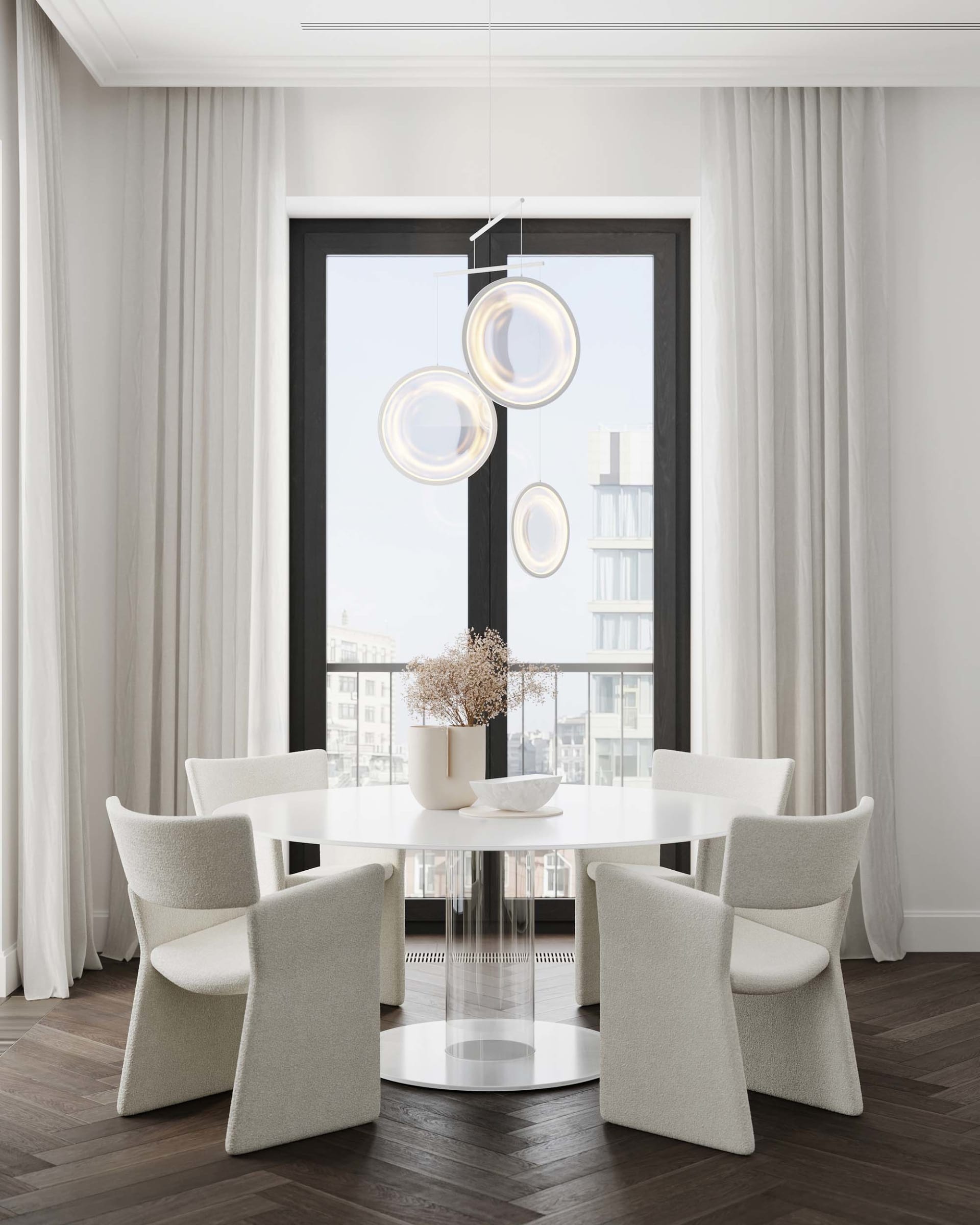 Modern dining room featuring fabric chairs, a glass table, and wooden flooring.