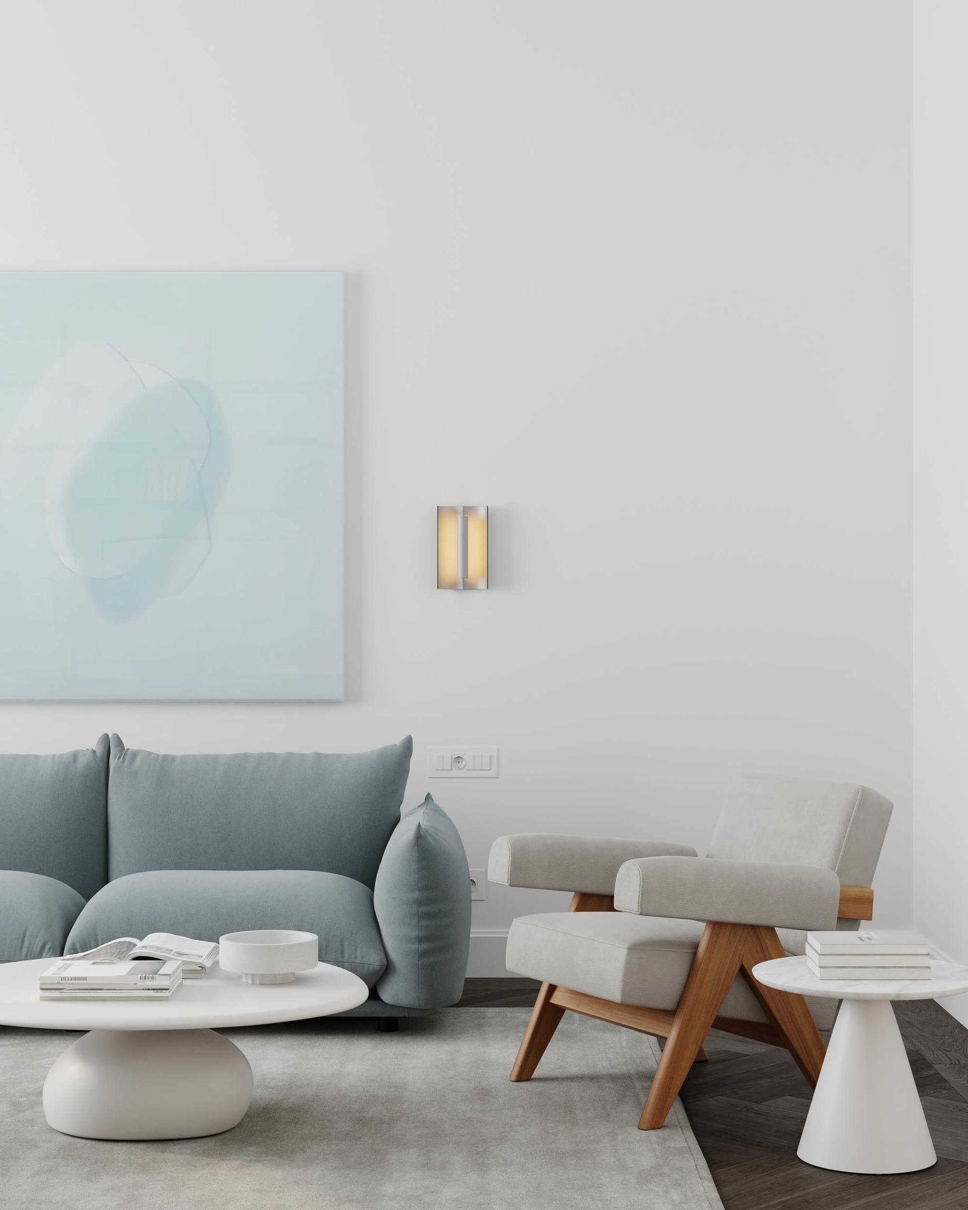 Contemporary minimalist living room featuring a modern sofa in soft pastel blue, a wooden armchair, and a round coffee table
