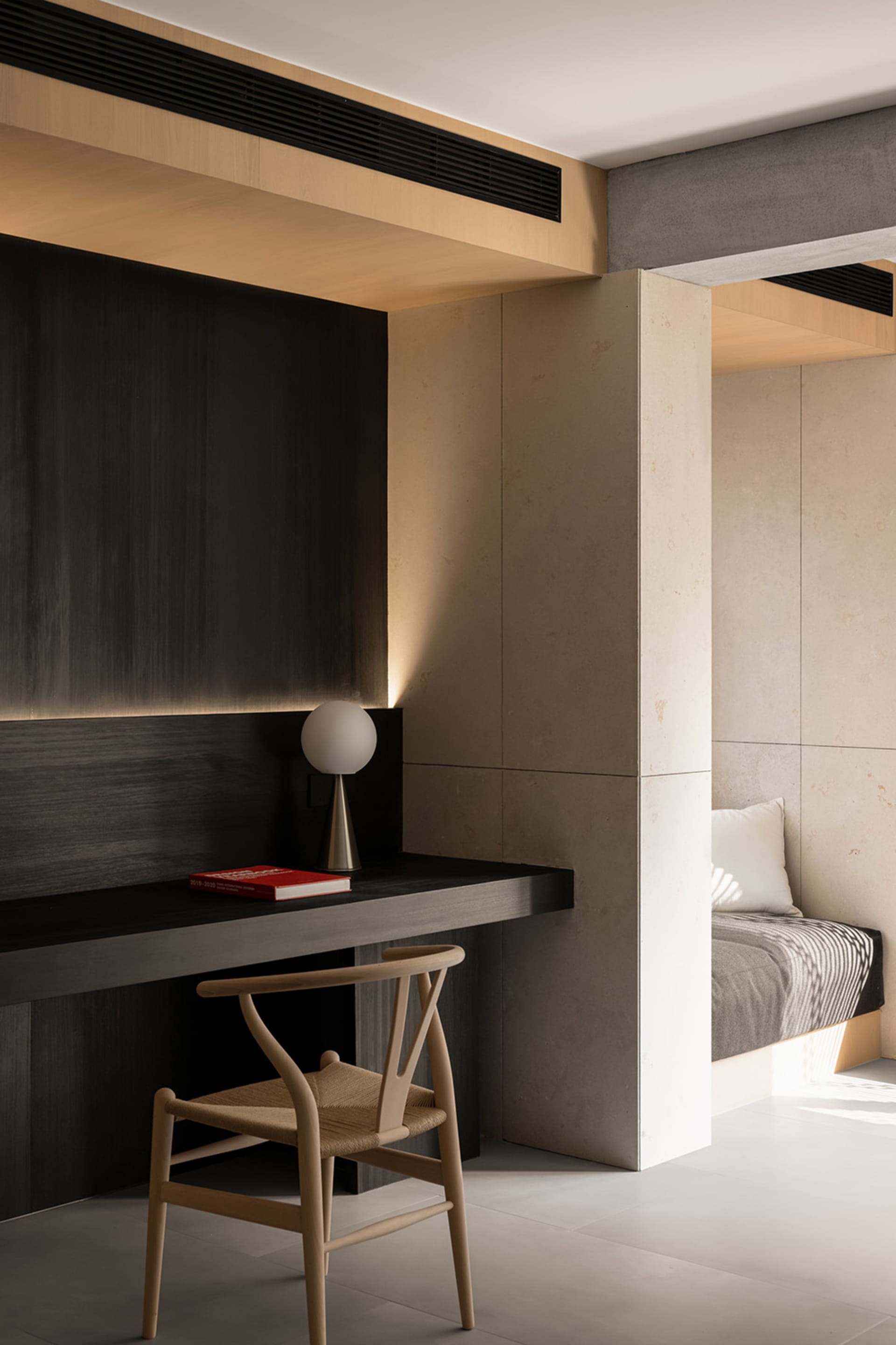 Modern minimalist bedroom featuring concrete and wood materials.