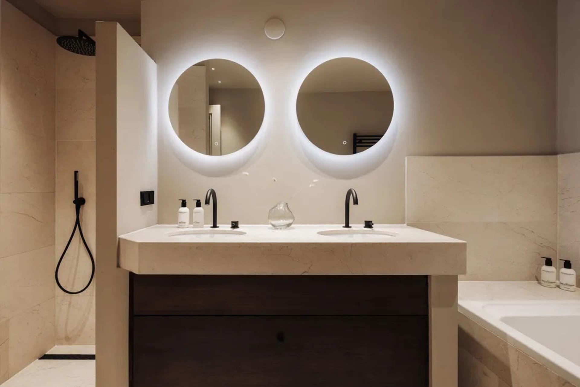 Modern bathroom with round mirrors and double sinks